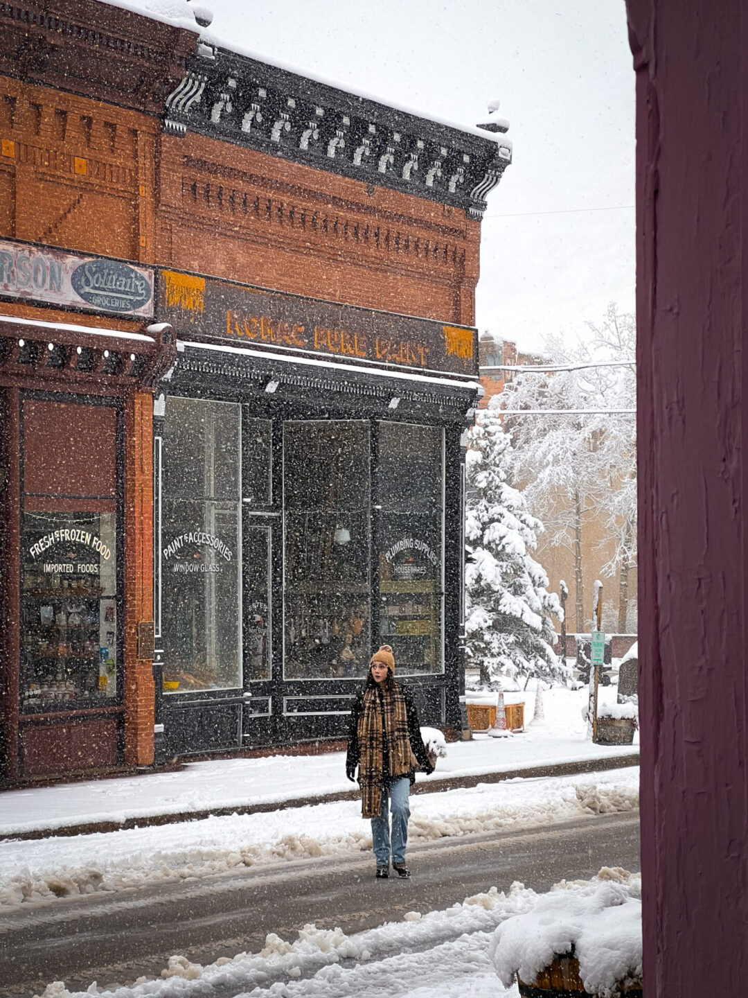 Travel Blogger Jordan Gassner walking across a street in Georgetown, Colorado during a blizzard