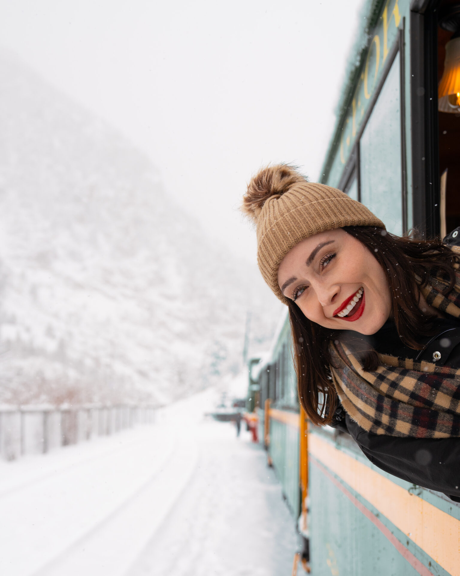Travel Blogger Jordan Gassner smiling from outside a train window in Georgetown Colorado