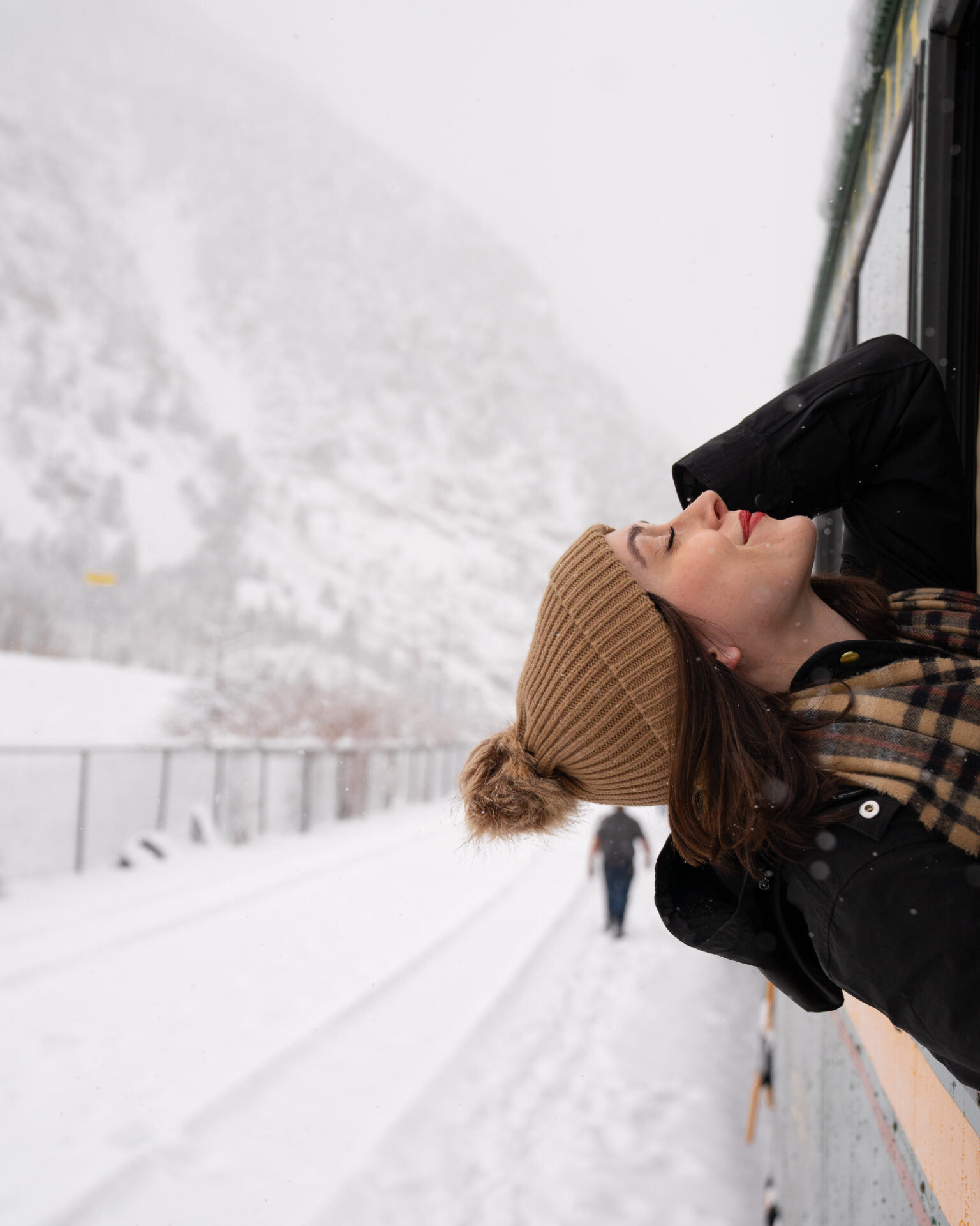 Georgetown Colorado Travel: Travel Blogger Jordan Gassner smiling while leaning back outside a window from the Georgetown Loop Railroad