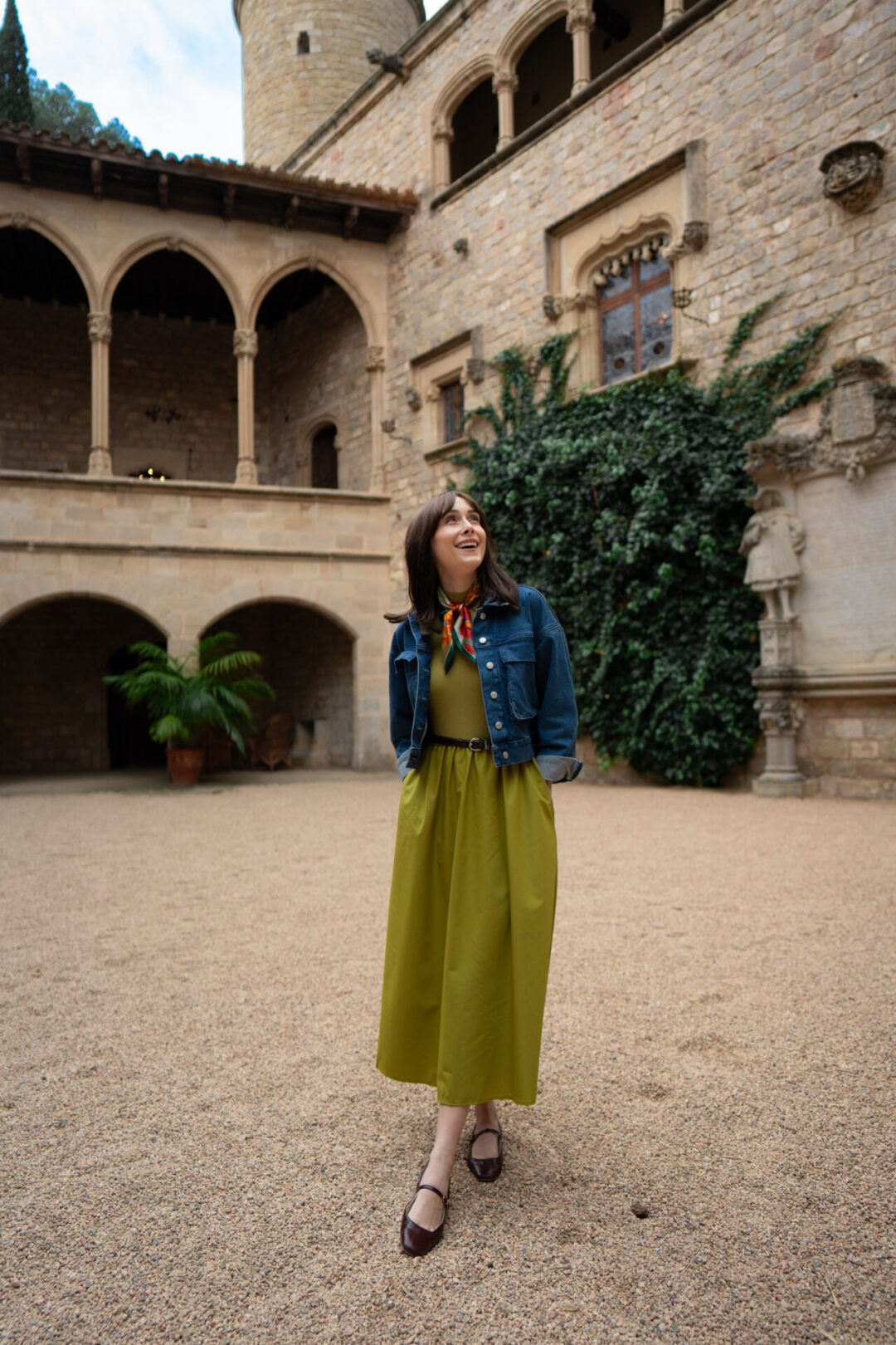 Travel Blogger Jordan Gassner smiling in the courtyard of Castell de Santa Florentina near Girona, Spain just outside of Barcelona