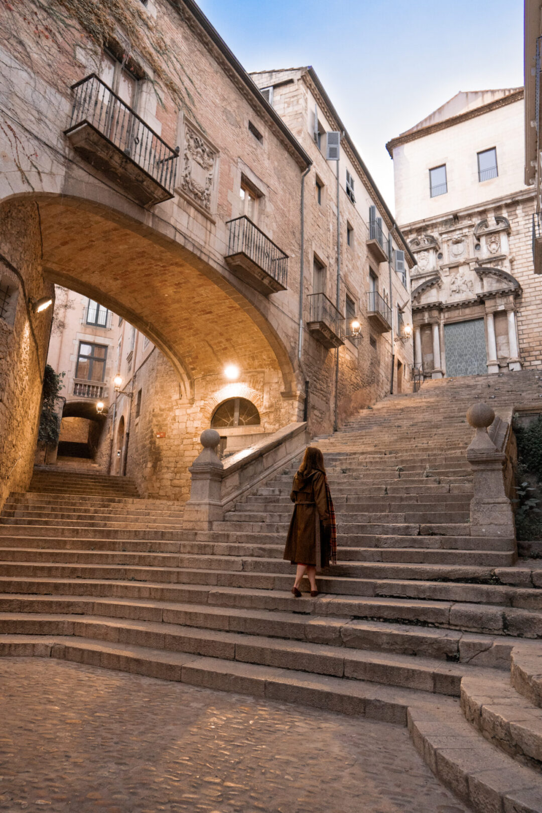 Travel Blogger Jordan Gassner climbing the steps of Sant Domenec - one of many Game of Thrones filming locations in Girona, Spain