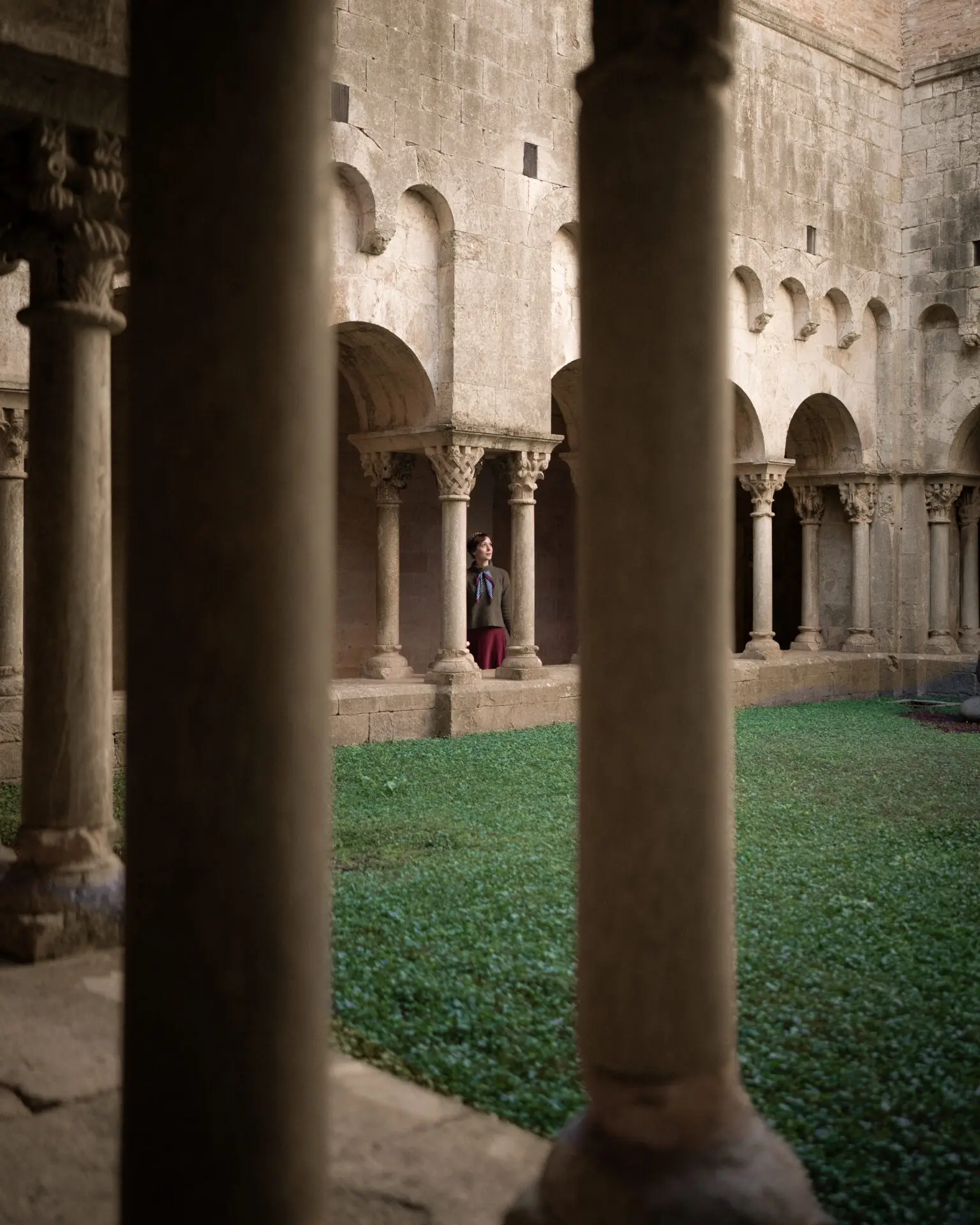 Travel Blogger Jordan Gassner standing in a courtyard filming location from Game of Thrones in Girona, Spain