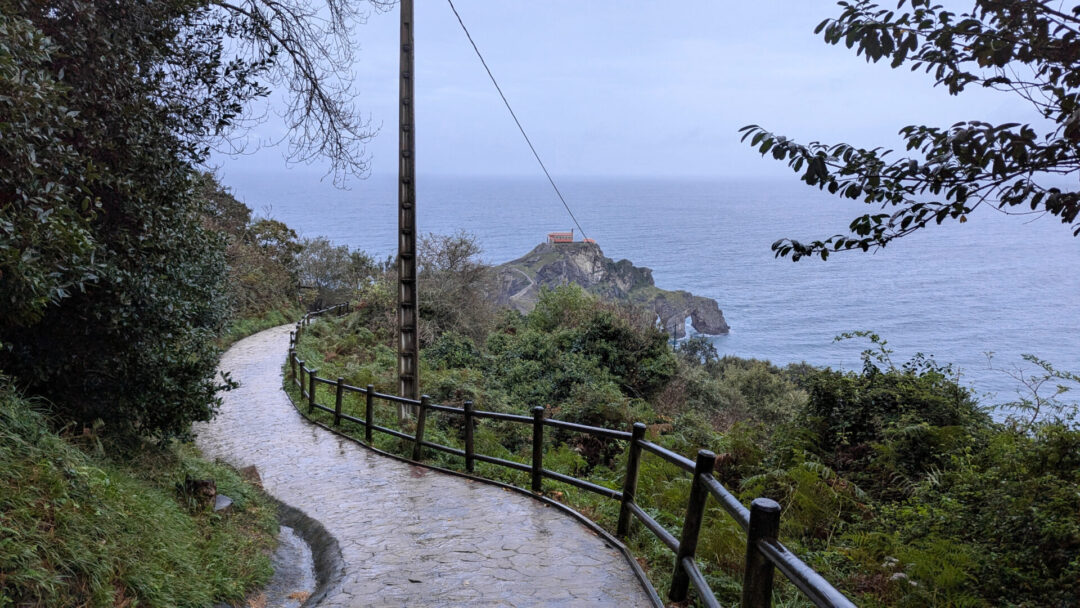 Visiting San Juan De Gaztelugatxe - A curving road leading down to the coast in Basque Country, Spain