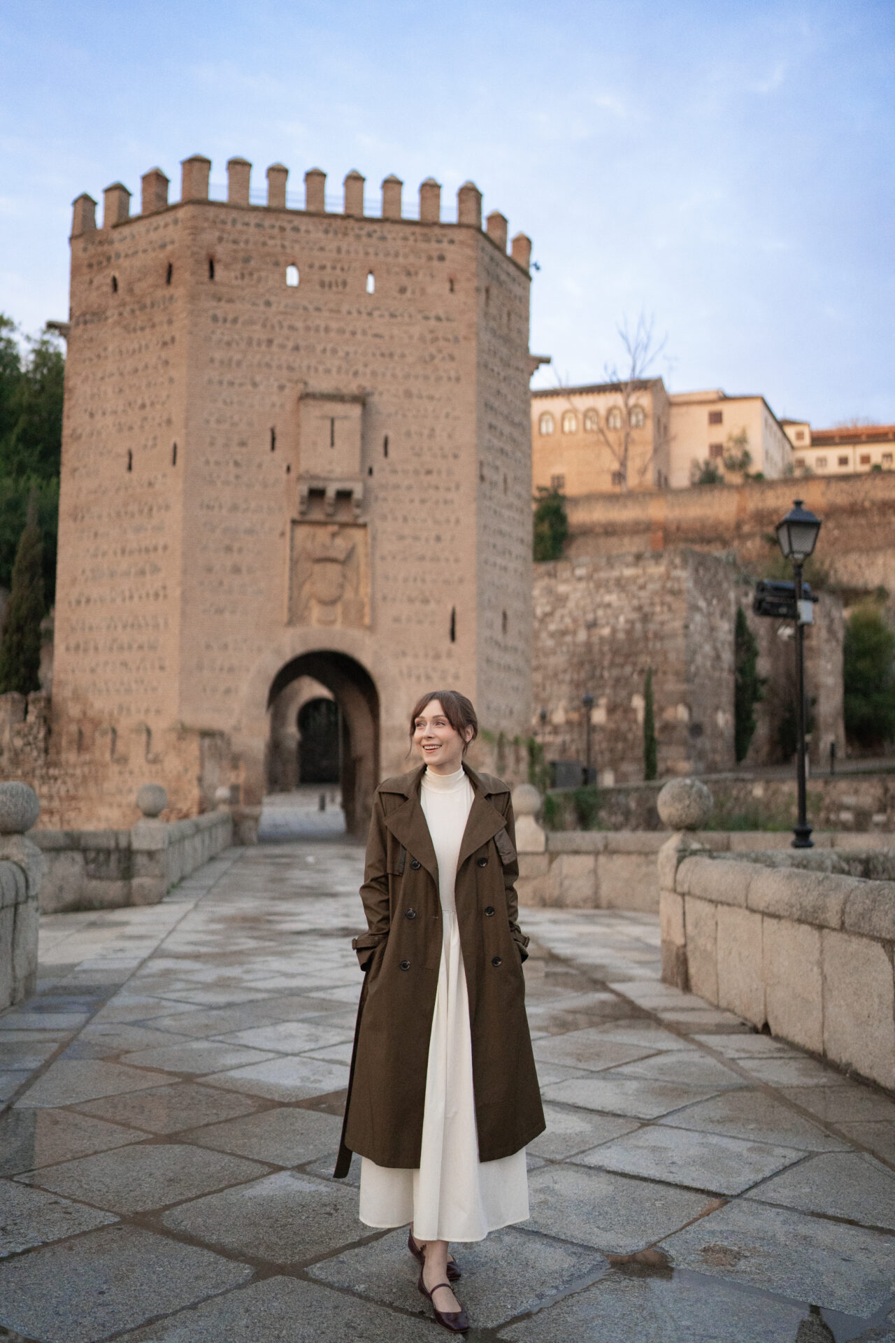 Toledo Spain Travel Guide - Travel Blogger Jordan Gassner walking along Alcantara Bridge just after sunrise in Toledo, Spain
