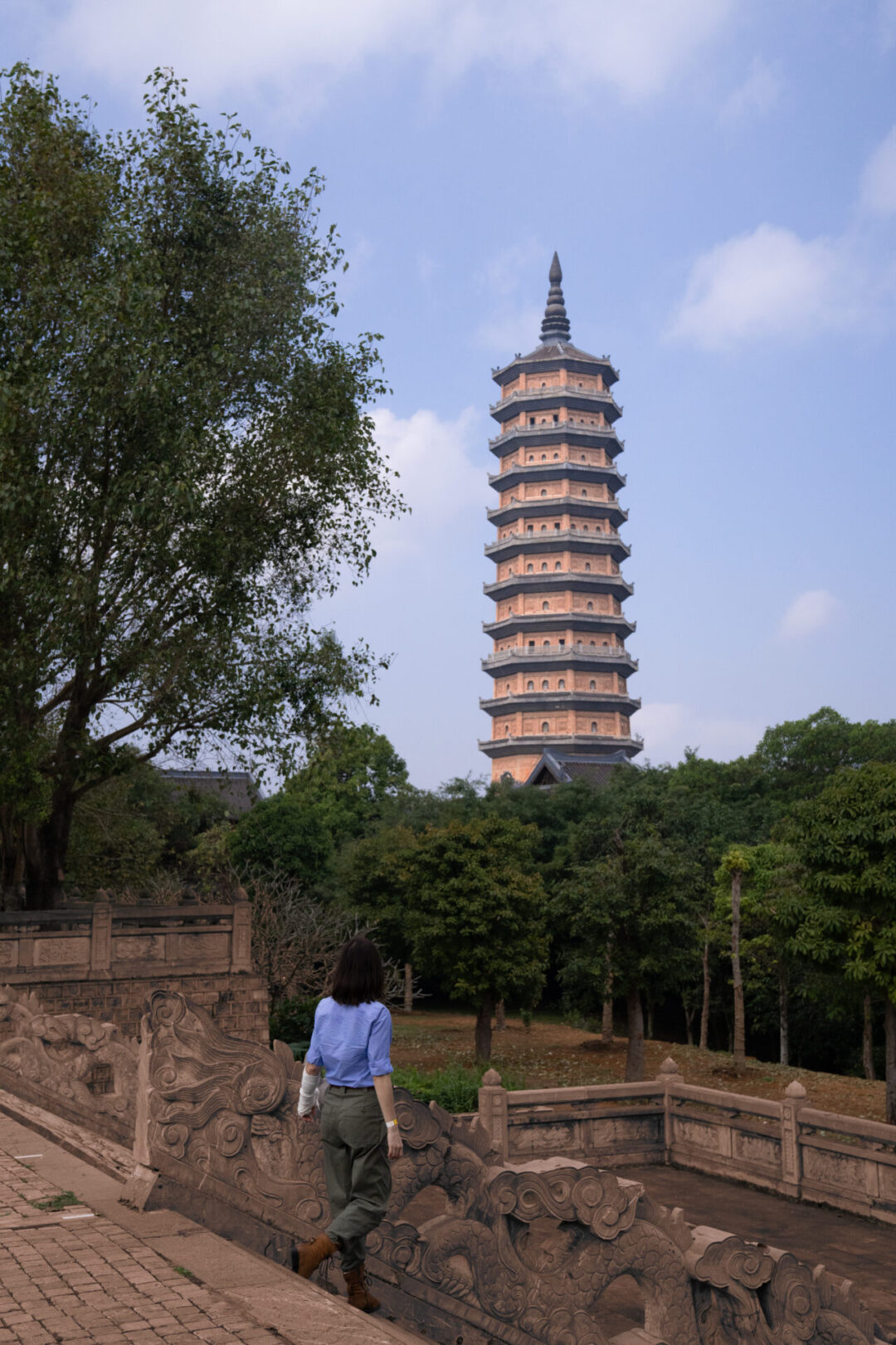 Travel Blogger Jordan Gassner climbing down the staircase of Bai Dinh Pagoda in Ninh Binh, Vietnam