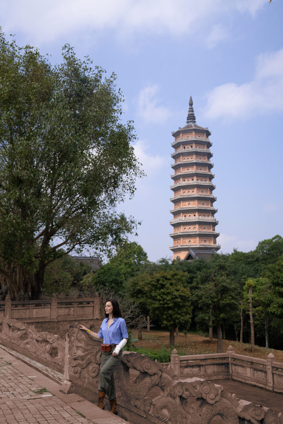 Travel Blogger Jordan Gassner standing along the staircase of Bai Dinh Pagoda in Ninh Binh, Vietnam
