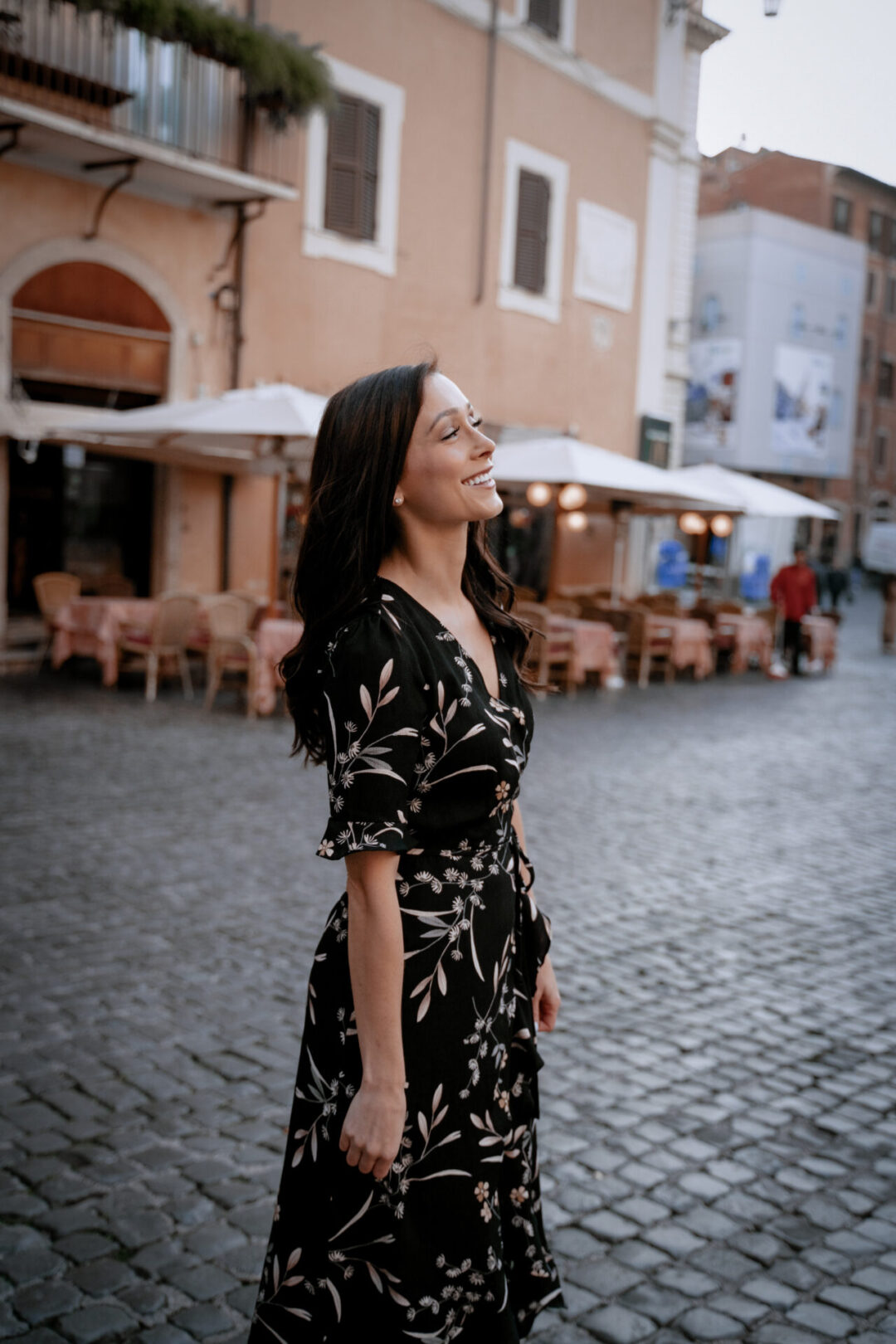 Travel Blogger Jordan Gassner smiling outside an al fresco dining spot just outside the Pantheon in Rome, Italy