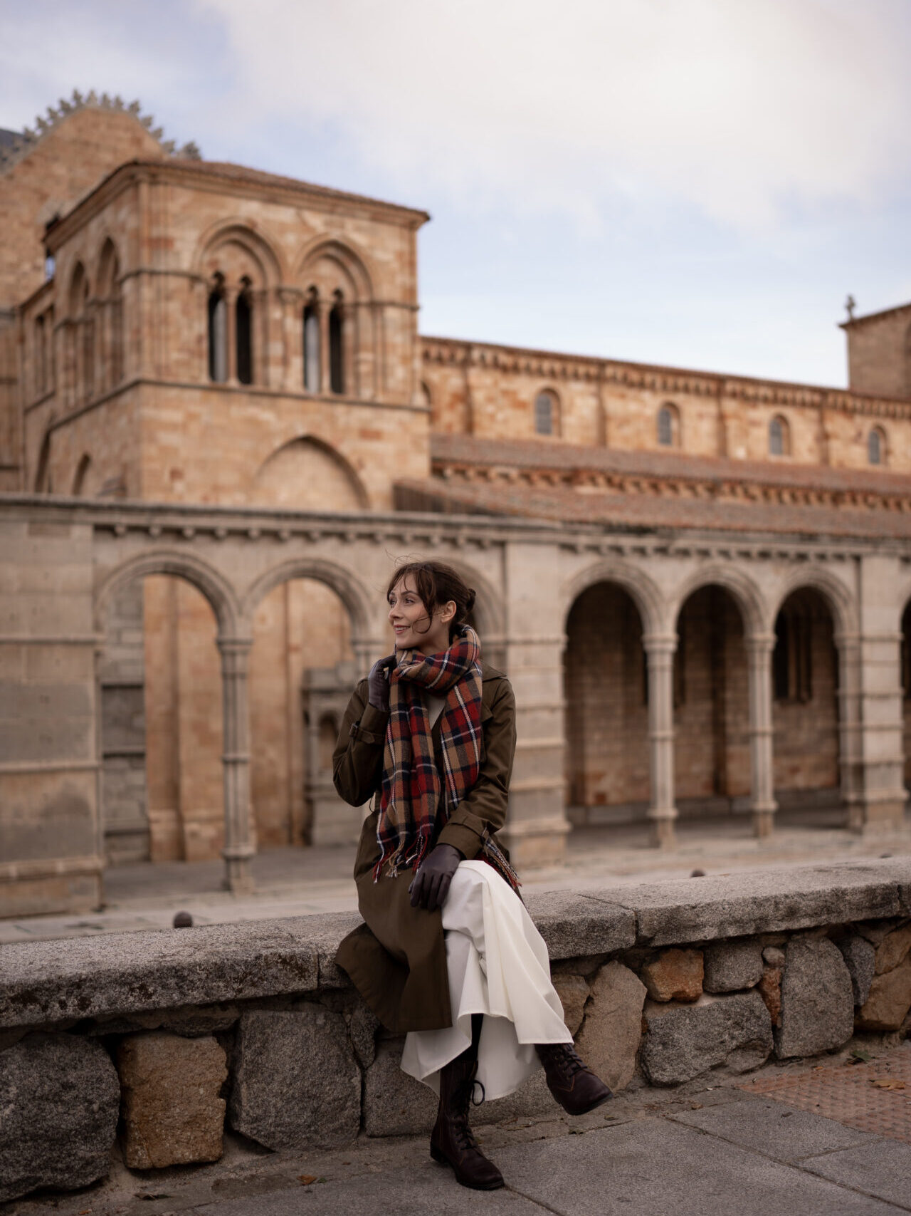 Travel Blogger Jordan Gassner sitting just outside the Basilica of San Vicente in Avila, Spain