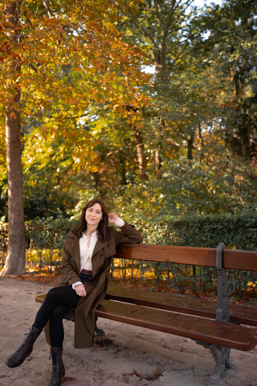 Things To Do In Madrid, Spain: Travel Blogger Jordan Gassner smiling while sitting on a bench in Retiro Park in Madrid, Spain