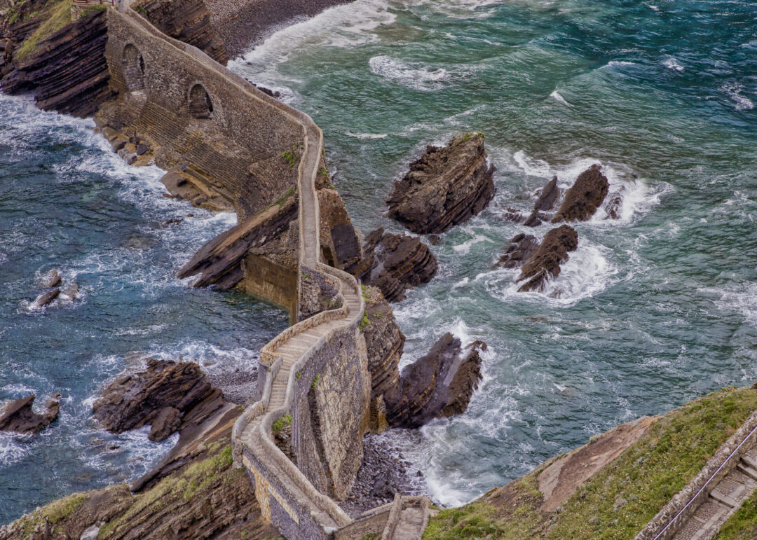 An overhead view from about halfway up the stone staircase at Gaztelugatxe islet in Bermeo, Basque Country, Spain, Europe