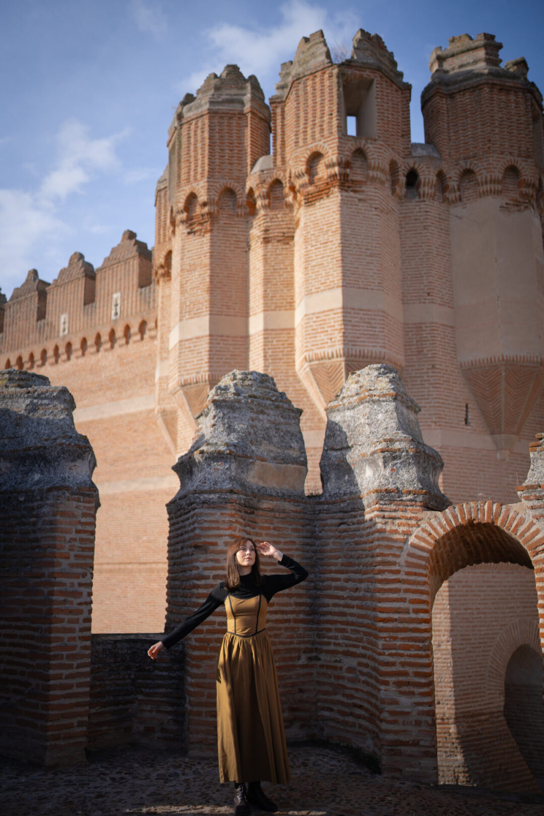 Travel Blogger Jordan Gassner standing in the sun from a spire on top of Castillo de Coca near Segovia, Spain