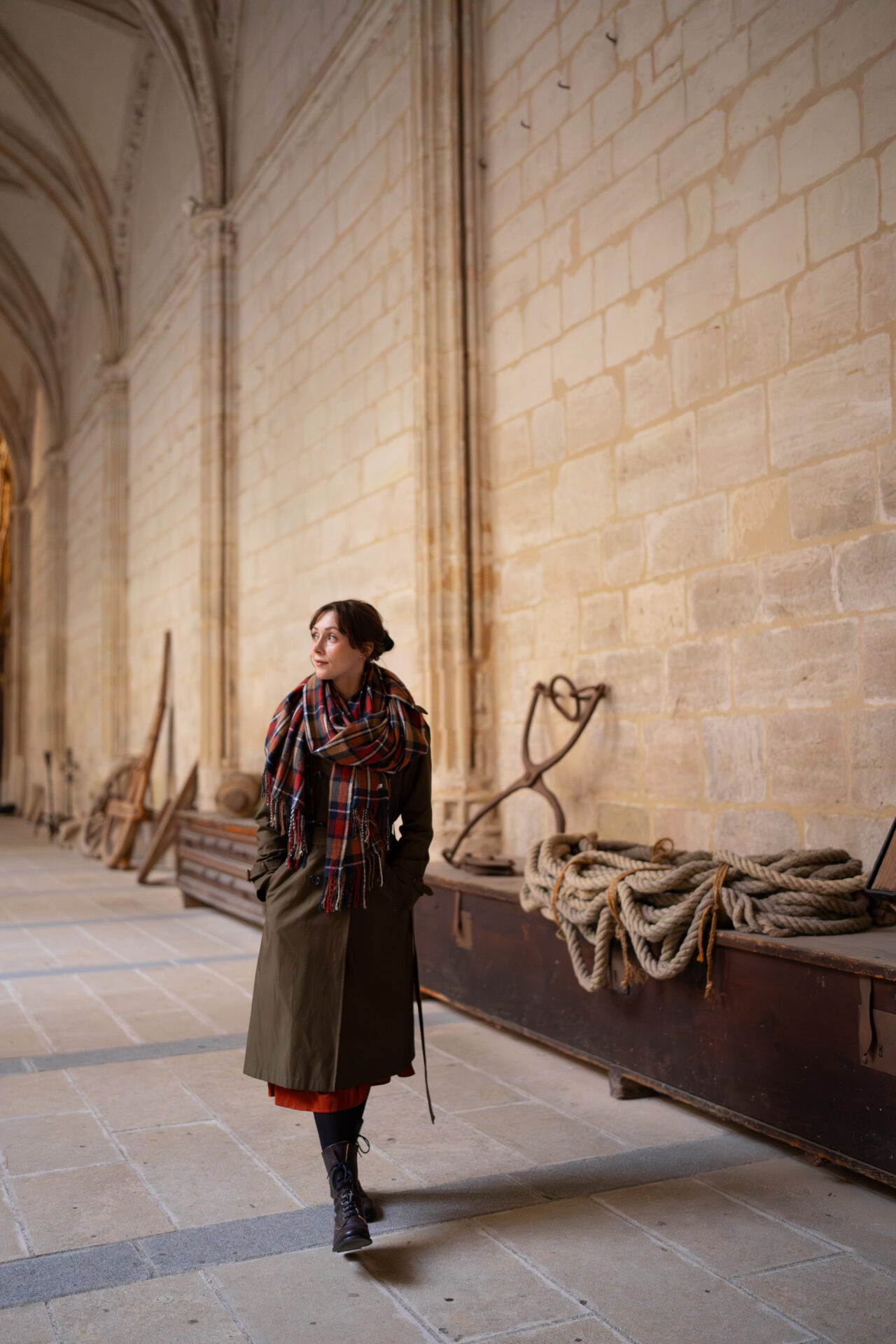 Travel Blogger Jordan Gassner looking to the right while walking down a corridor in the cloister of the Segovia Cathedral in Spain