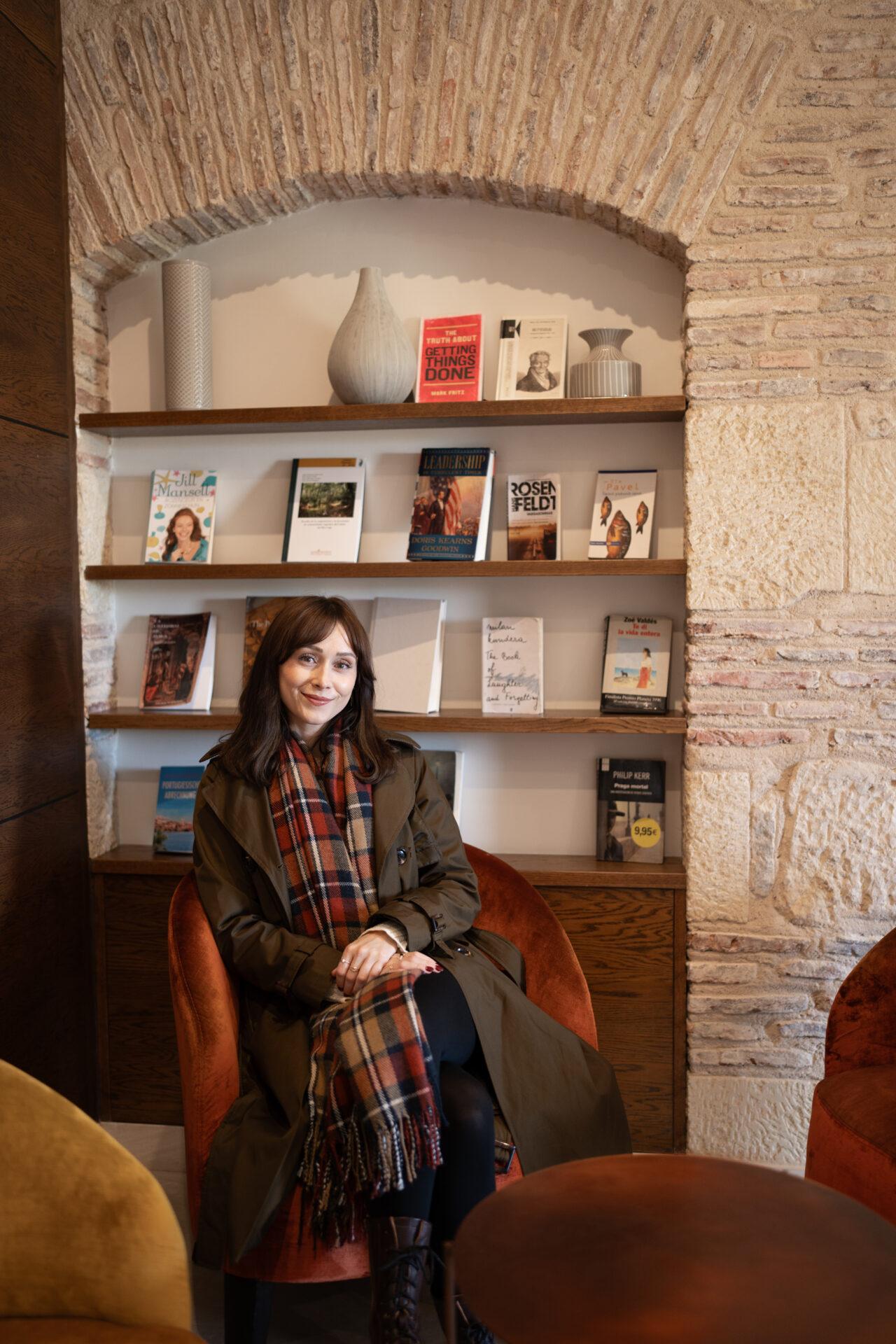 Travel Blogger Jordan Gassner sitting inside a reading nook at a hotel in Segovia, Spain
