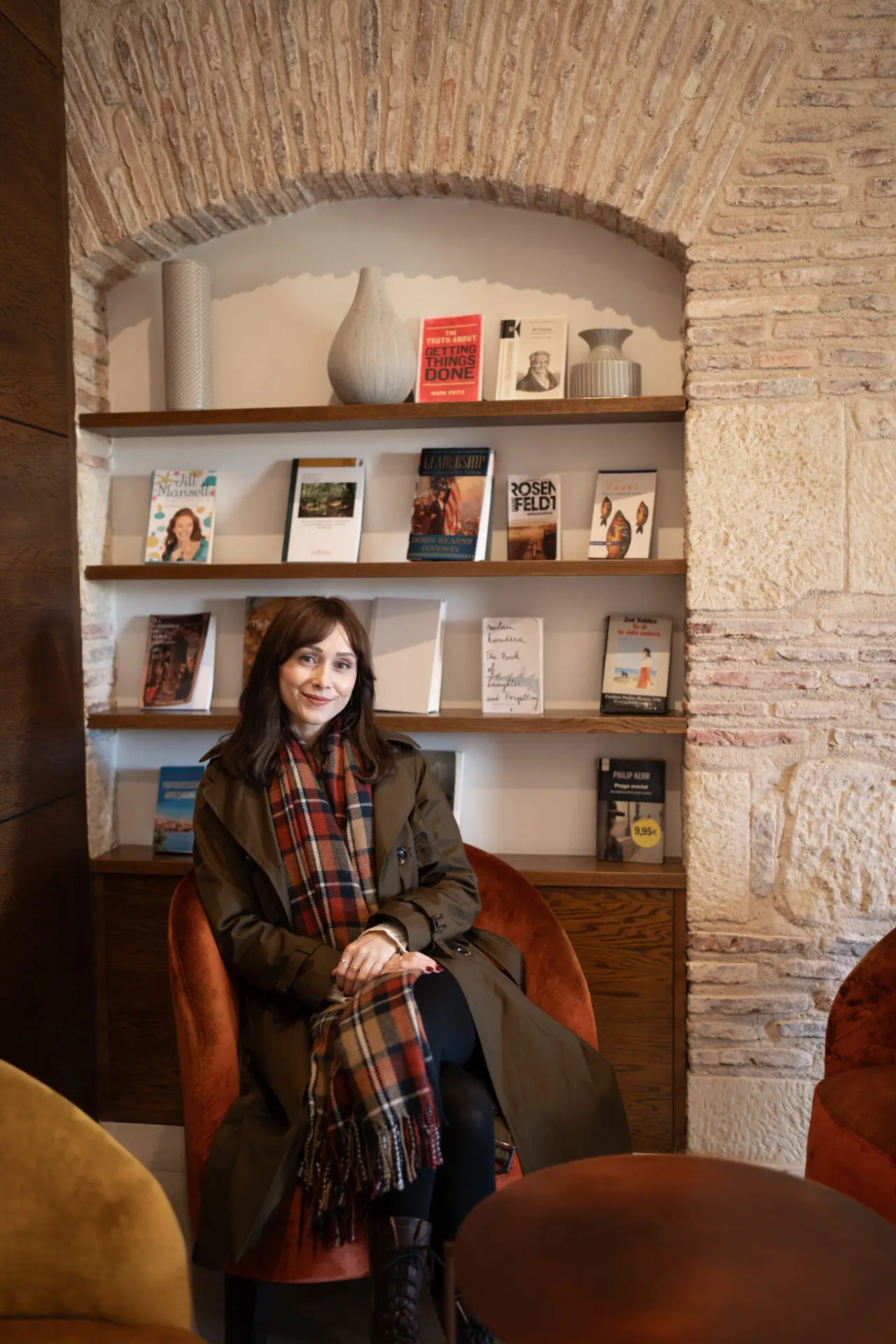 Travel Blogger Jordan Gassner sitting inside a reading nook at a hotel in Segovia, Spain