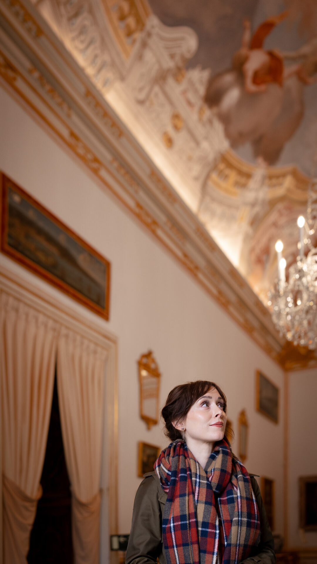 Travel Blogger Jordan Gassner looking at a piece of artwork inside the Royal Palace of La Granja of San Ildefonso in Segovia, Spain