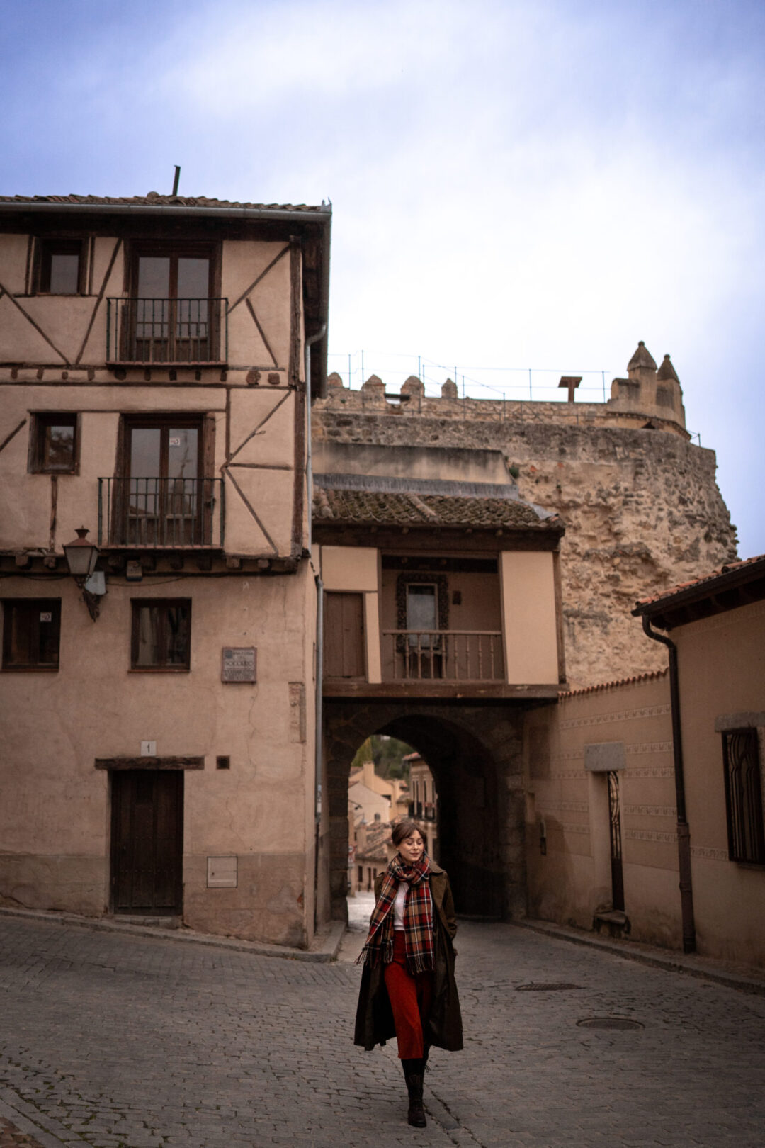 Travel Blogger Jordan Gassner walking away from la Puerta de San Andres in Segovia, Spain