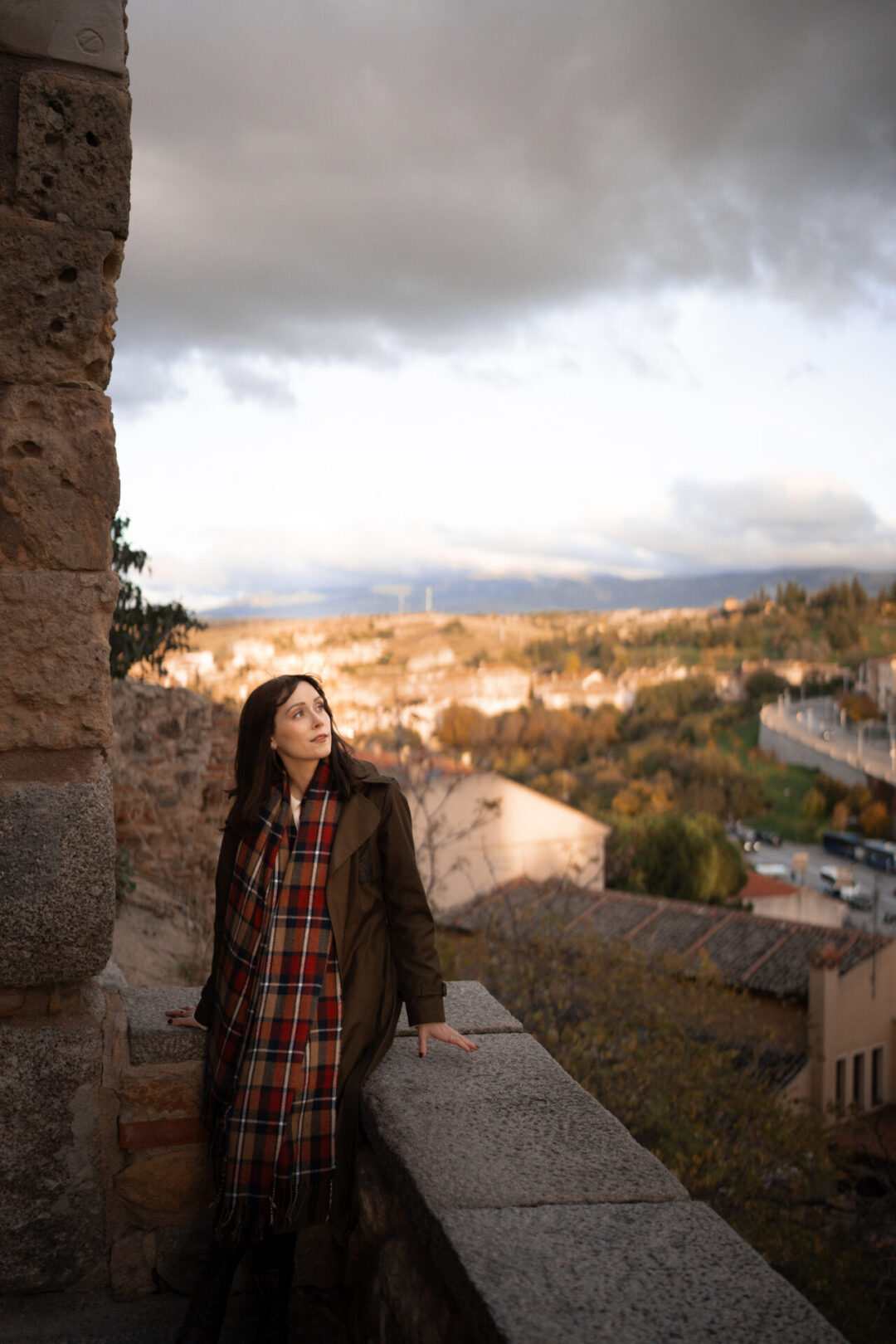 Travel Blogger Jordan Gassner looking out from a balcony overlooking Segovia, Spain