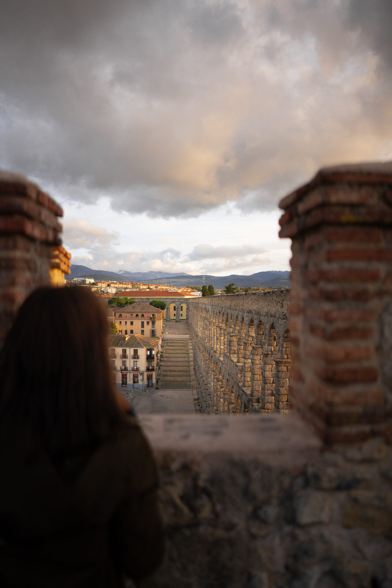 Travel Blogger Jordan Gassner looking toward Segovia's famous Roman aqueduct in Spain