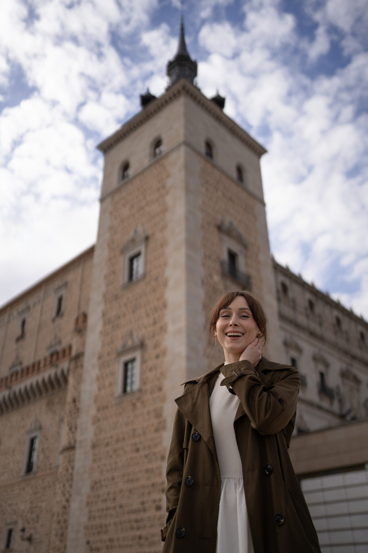 Travel Blogger Jordan Gassner smiling in front of the Alcazar of Toledo, Spain