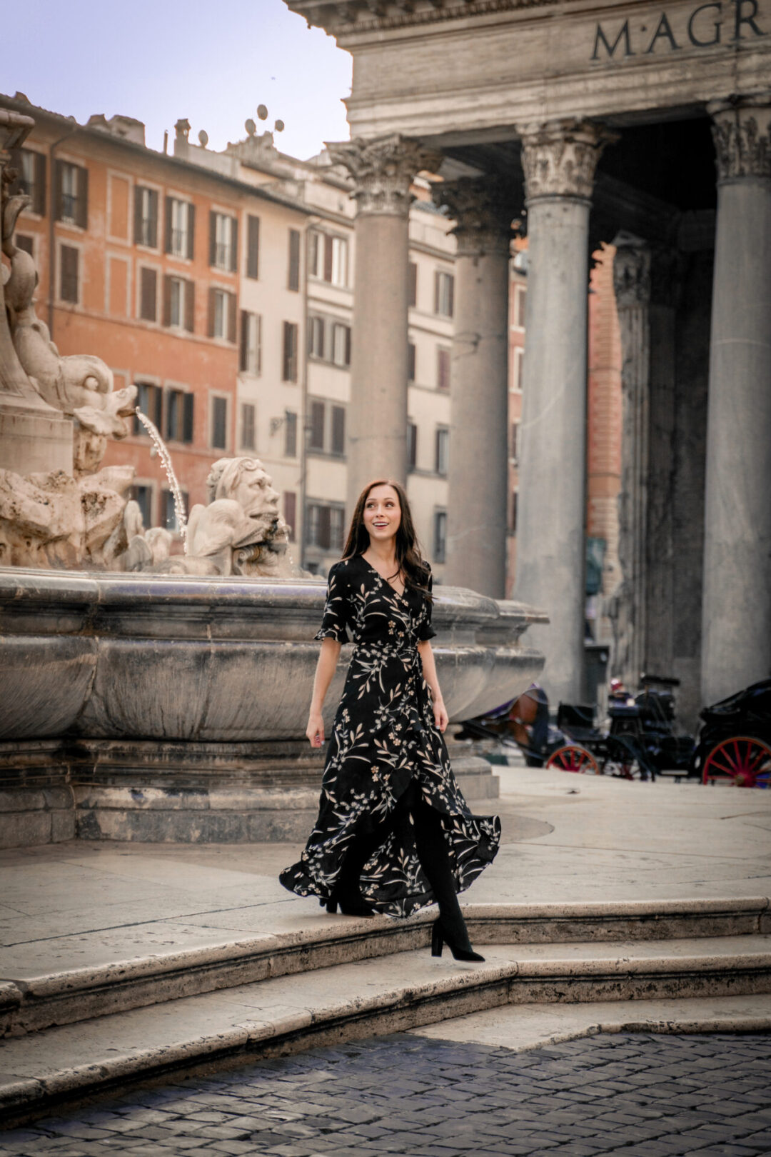 Travel Blogger Jordan Gassner smiling while walking down the steps of the fountain in front of the Pantheon in Rome, Italy