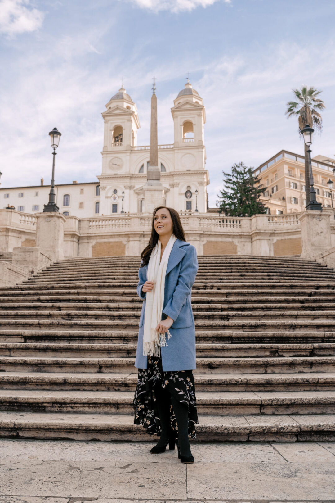Travel Blogger Jordan Gassner smiling from the bottom of the Spanish Steps in Rome, Italy