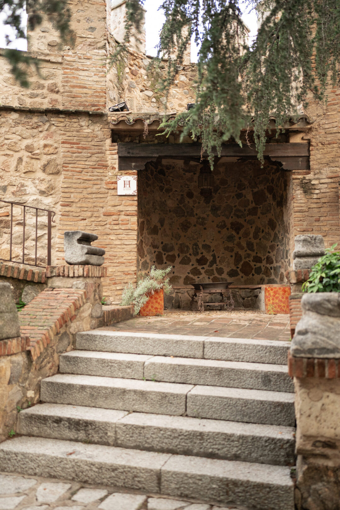 A set of stairs leading up to a medieval wall at Hotel Hacienda del Cardinal in Toledo, Spain