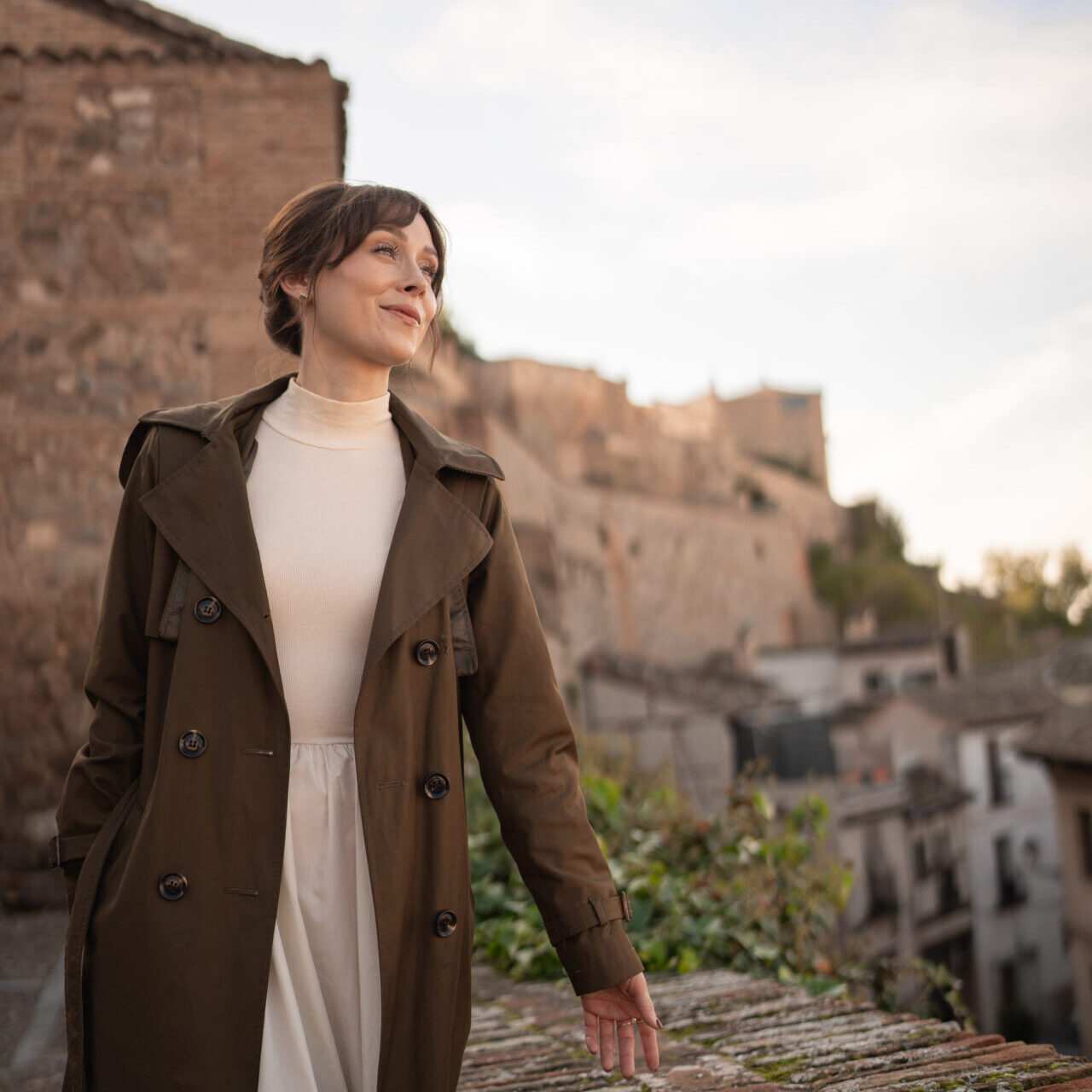 Travel Blogger Jordan Gassner smiling while walking near an overlook in the city of Toledo, Spain