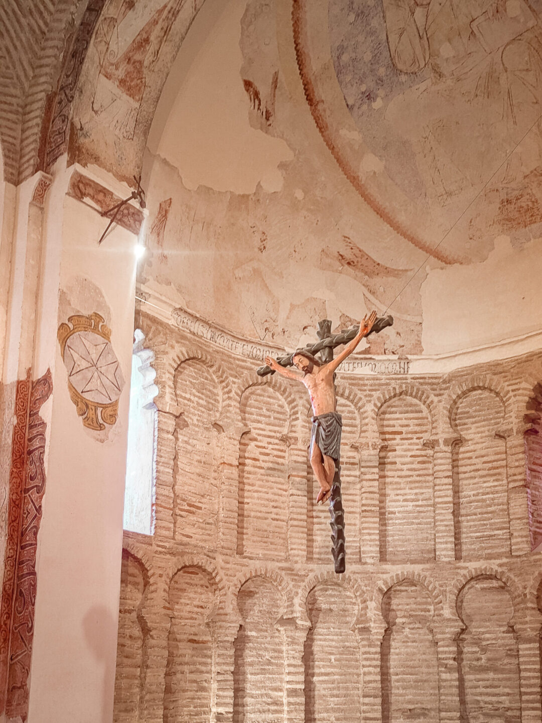 A hanging sculpture of Jesus on a cross inside the mosque-turned-church, la Mezquita del Criso de la Luz, in Toledo, Spain