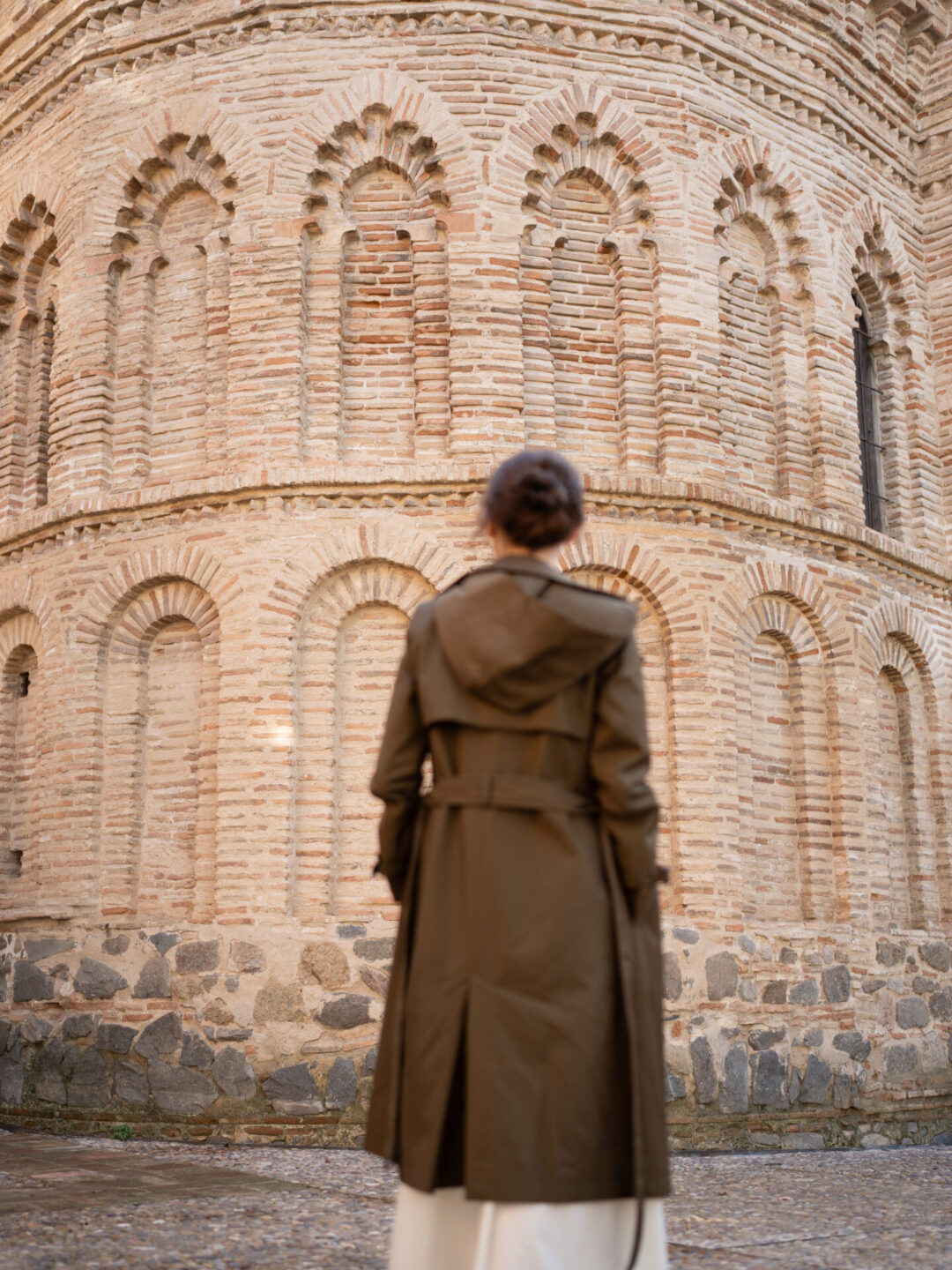 Toledo Spain Travel Guide - Travel Blogger Jordan Gassner standing outside the circular brick building known as Mezquita del Criso de la Luz, in Toledo, Spain