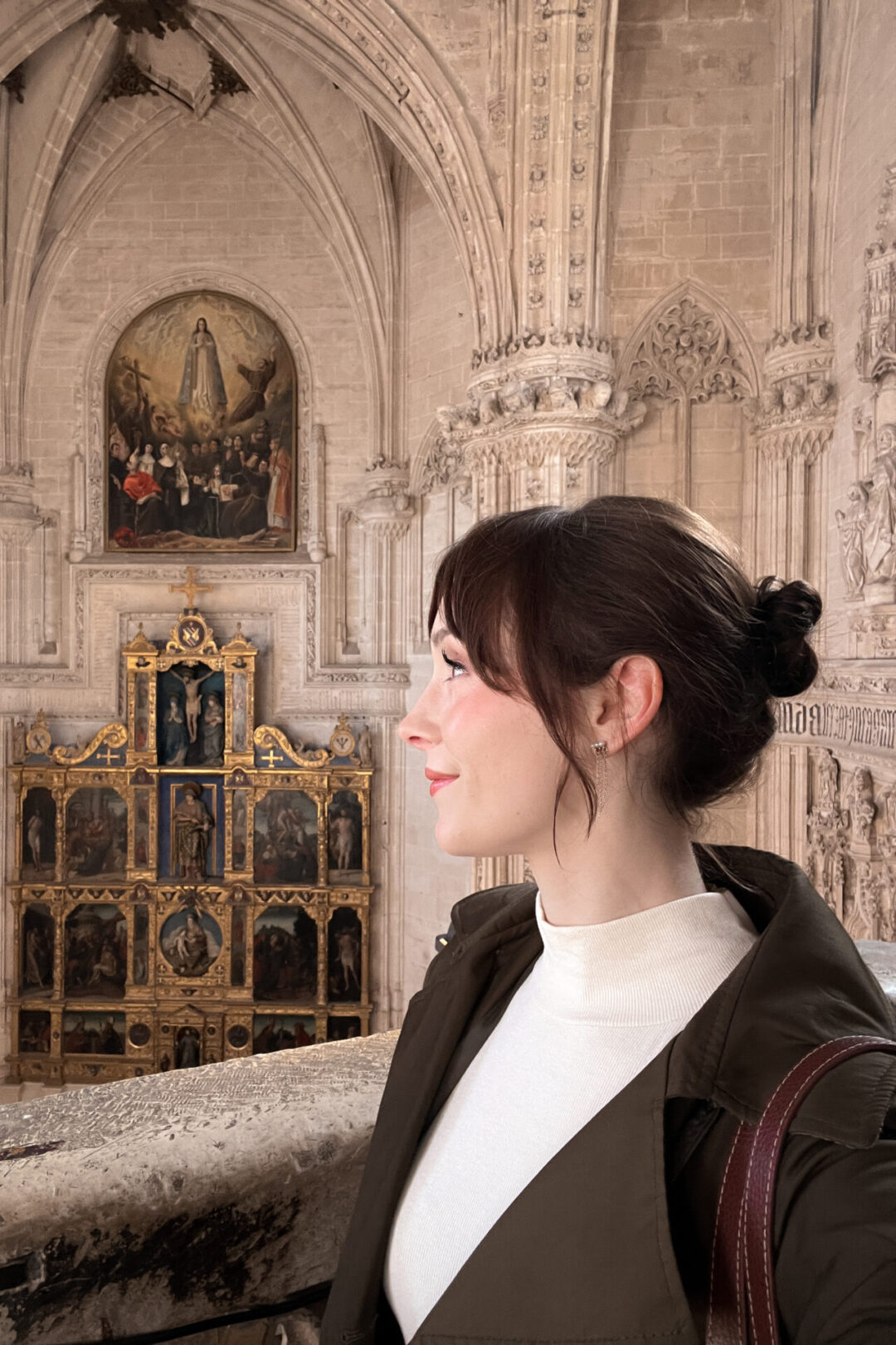 Travel Blogger Jordan Gassner smiling inside a medieval church in Toledo Spain