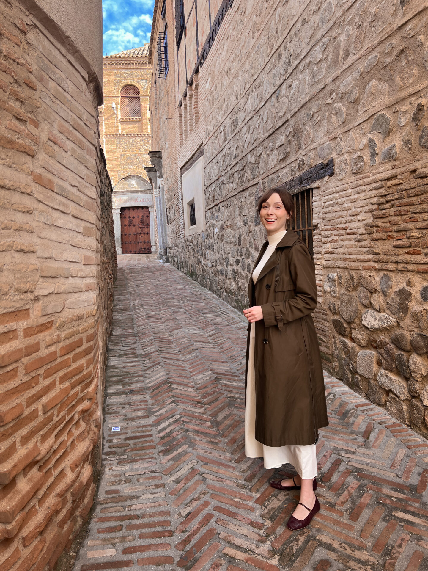 Toledo Spain Travel Guide - Travel Blogger Jordan Gassner smiling outside the entrance to the El Greco Museum in Toledo, Spain