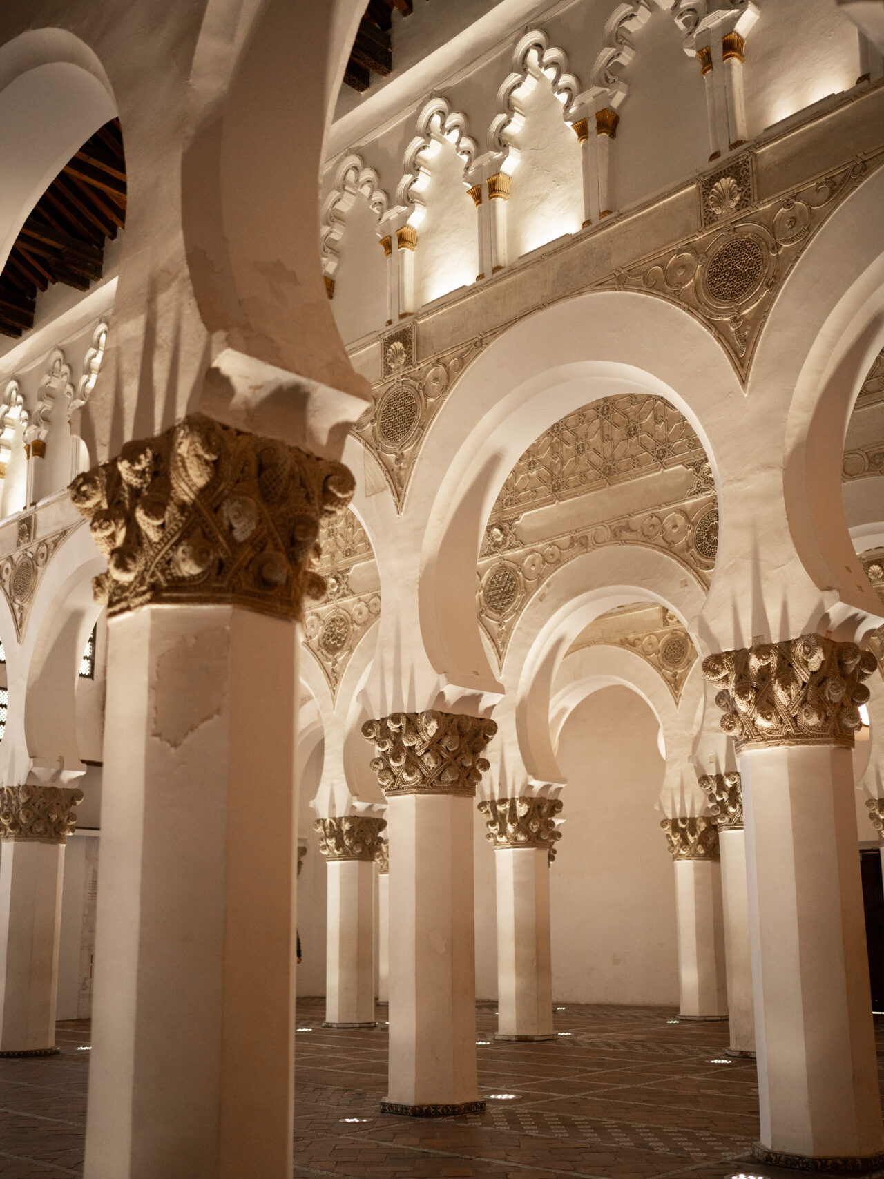 The beautifully decorated horseshoe arches inside Sinagoga de Santa María La Blanca, a 13th century synagogue in Toledo, Spain