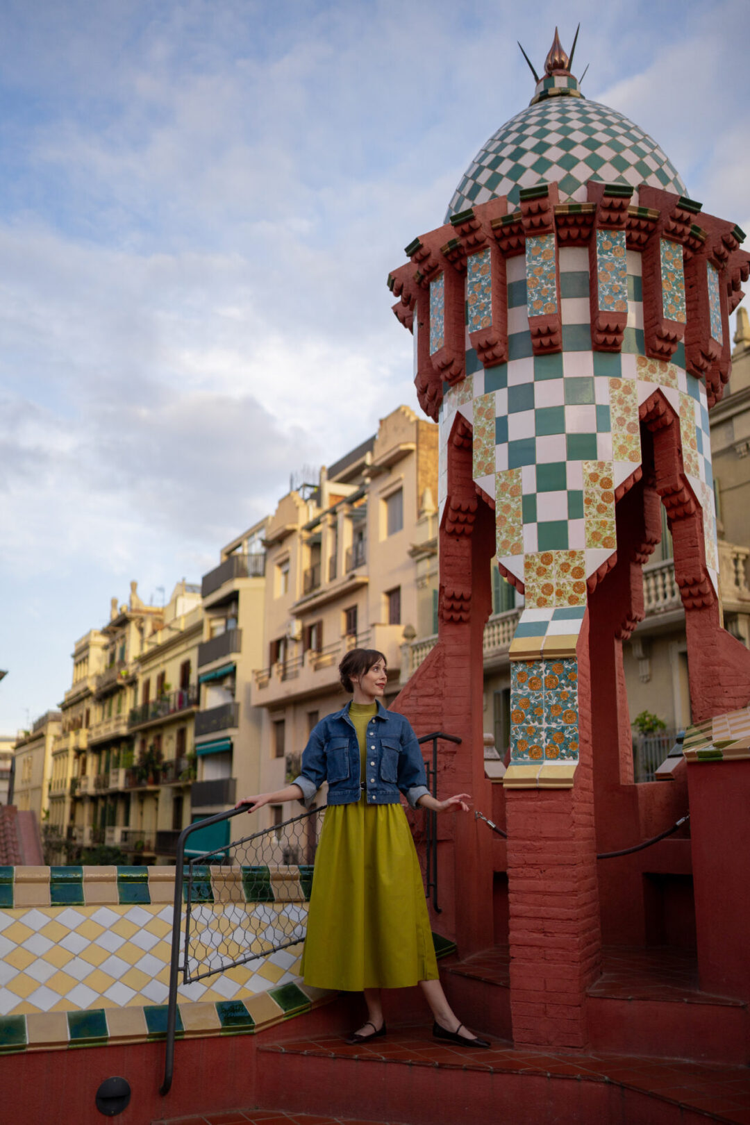 Travel Blogger Jordan Gassner standing near a domed archway atop the roof of Casa Vicens in Barcelona, Spain