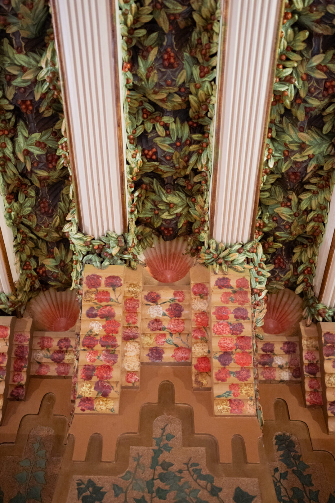 A leafy green designed ceiling with berries, shells and roses inside one of the rooms at Casa Vicens in Barcelona, Spain
