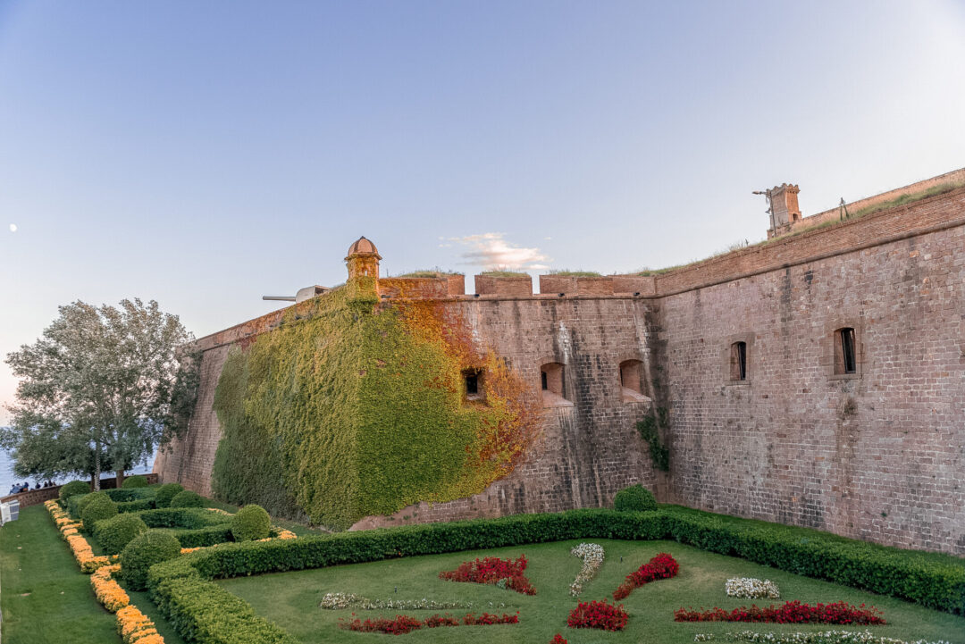 The side of Montjuic Castle, an old military fortress built on top of Montjuïc Hill in Barcelona, Spain on a clear blue day