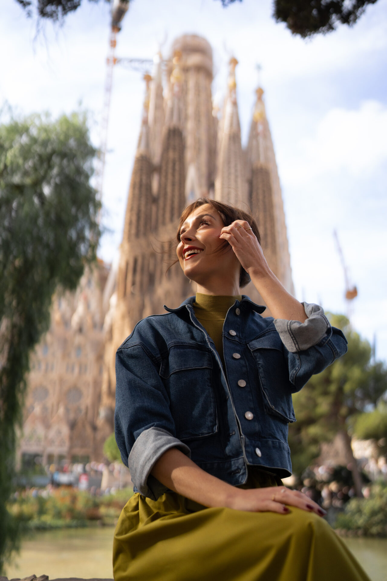 Travel Blogger Jordan Gassner smiling in front of Sagrada Familia in Barcelona, Spain