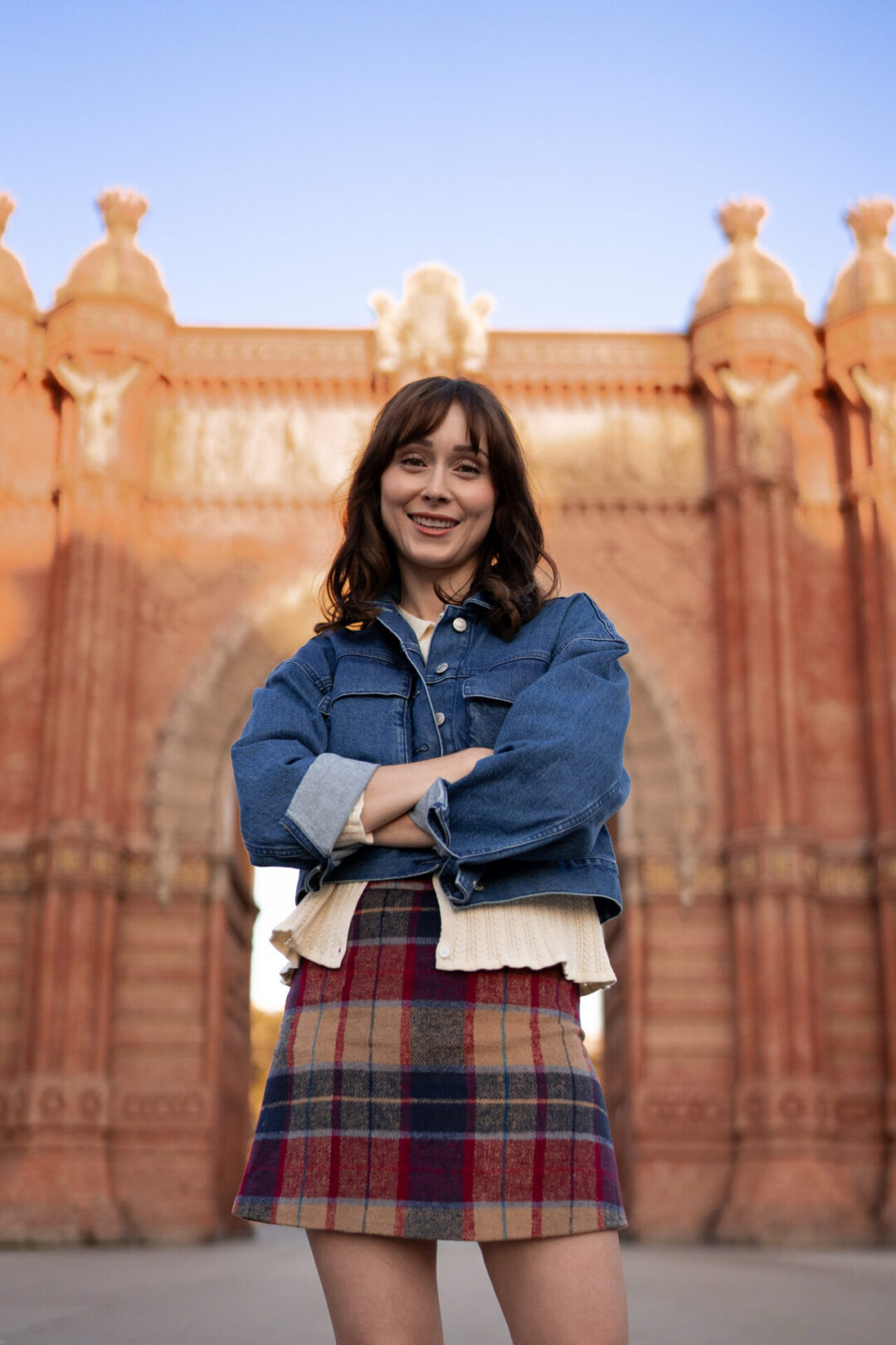 First Time in Barcelona: Travel Blogger Jordan Gassner smiling with her arms crossed in front of the Arc de Triomf in Ciutadella Park in Barcelona, Spain