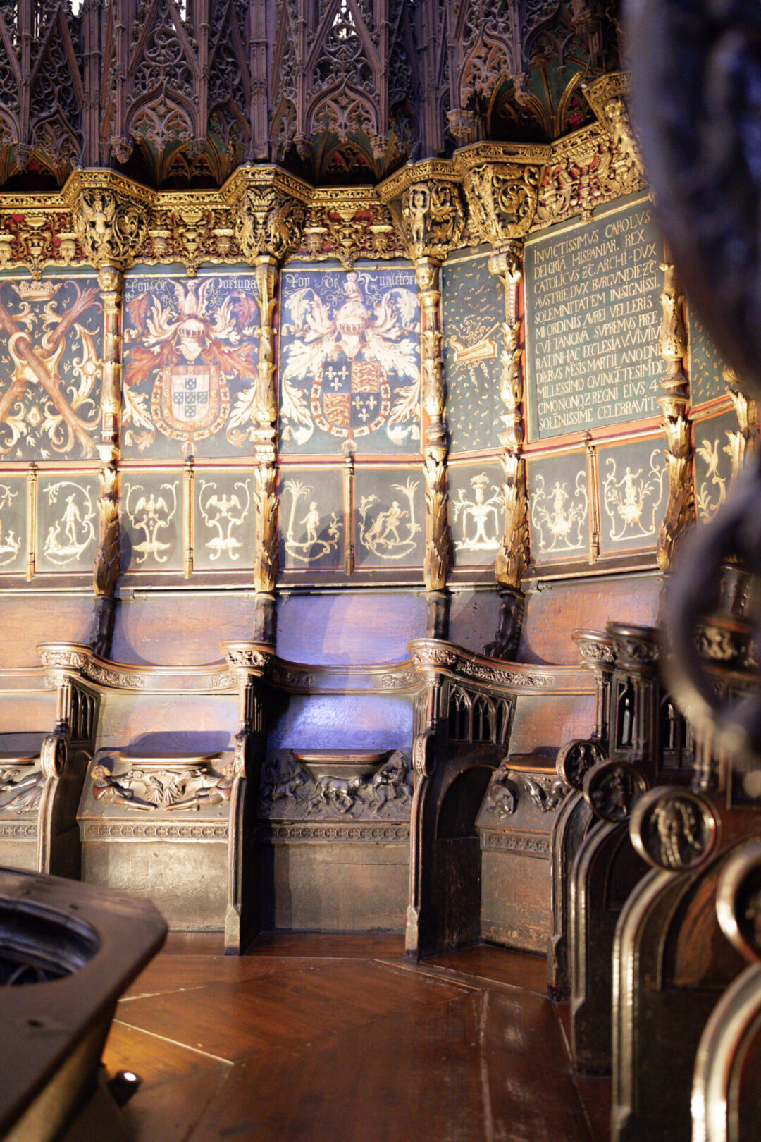 A grouping of old medieval seats made of wood inside one of the more sacred areas of Barcelona Cathedral in Spain