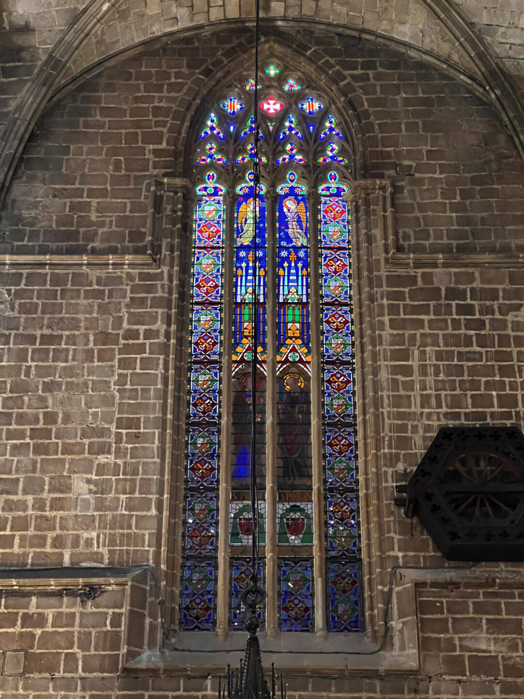 A close-up view of one of the massive stained windows inside Barcelona Cathedral in Spain