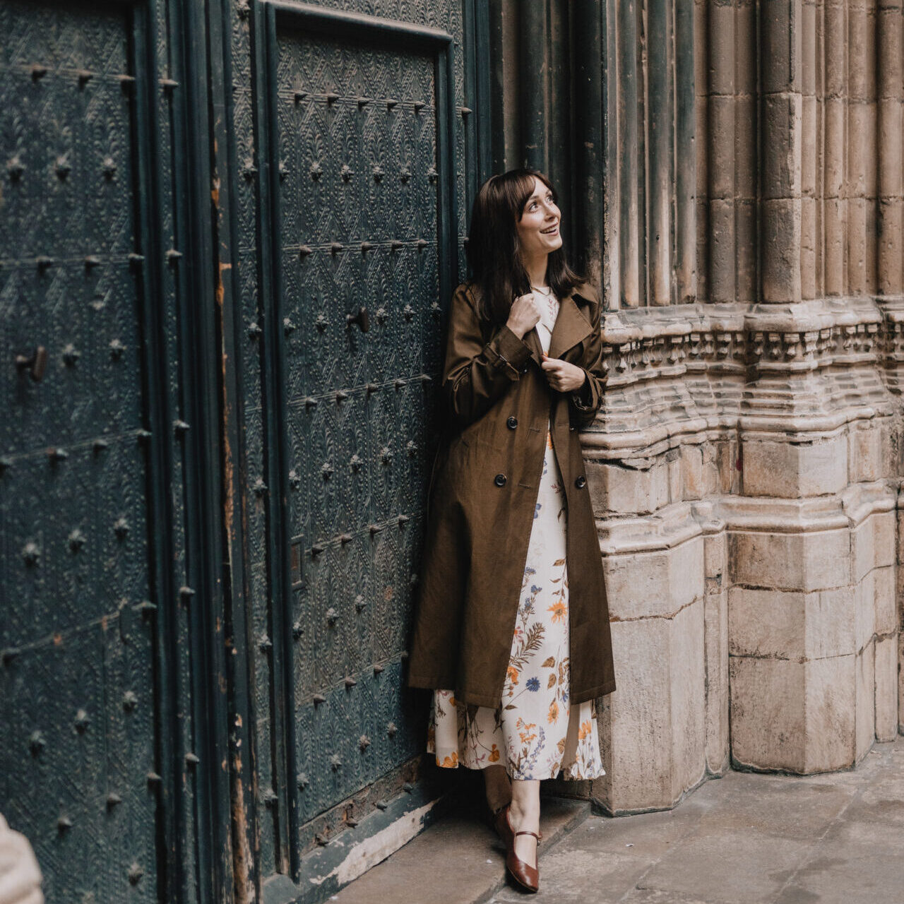 First Time in Barcelona: Travel Blogger Jordan Gassner smiling while leaning against a metal door outside of Barcelona Cathedral in Spain