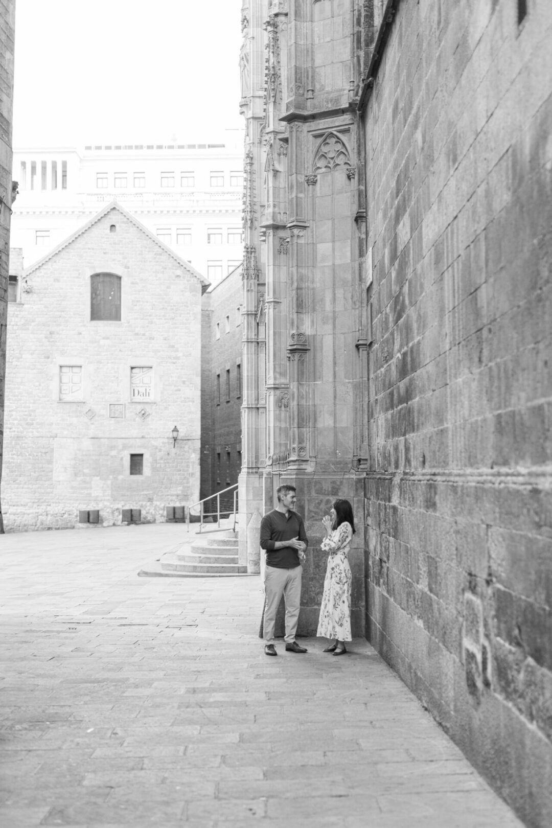 Travel Blogger Jordan Gassner and her partner laughing in front of Barcelona Cathedral in the Gothic Quarter in Barcelona, Spain