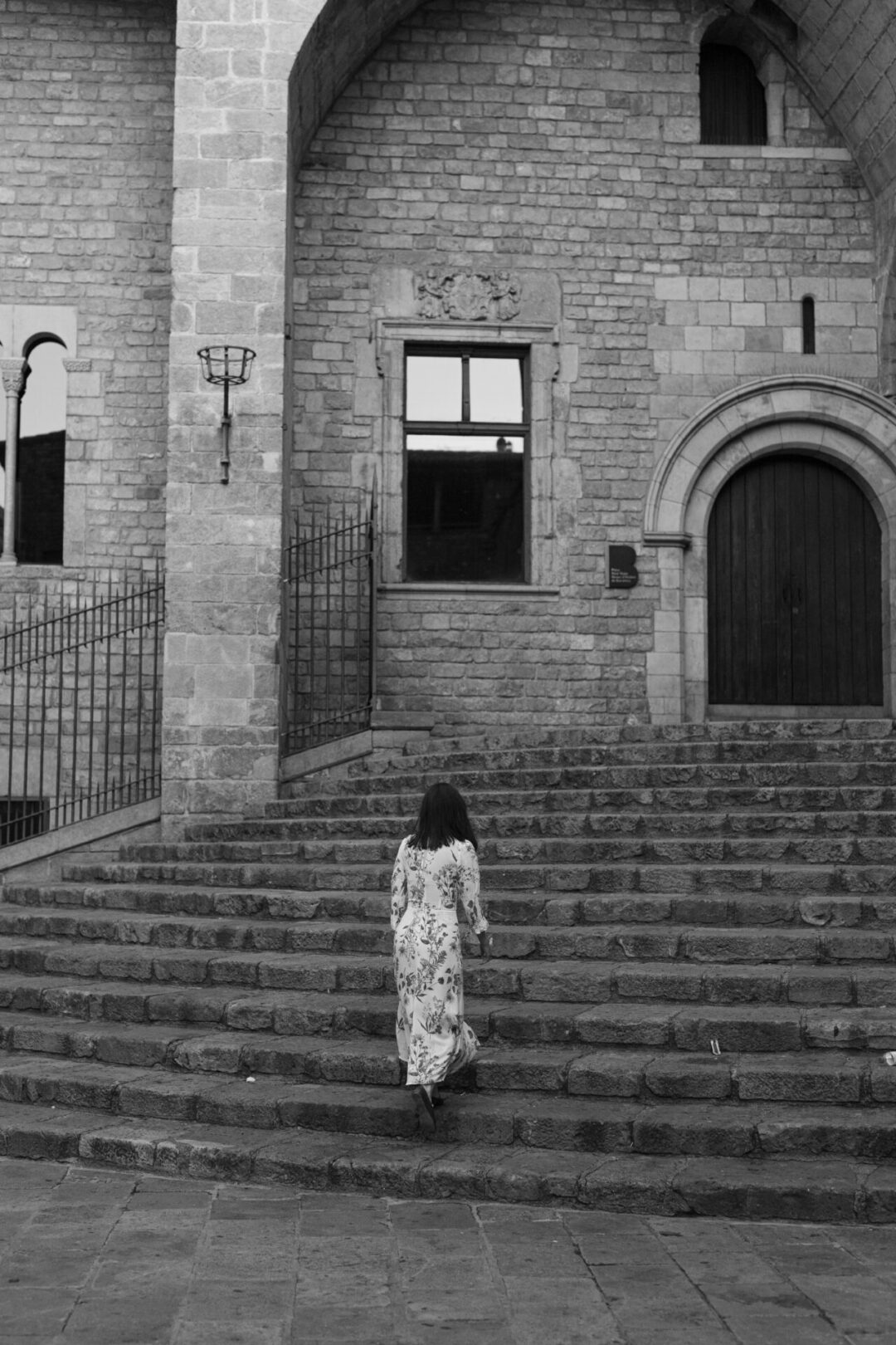Travel Blogger Jordan Gassner walking up the steps at Placa del Rei in Barcelona, Spain