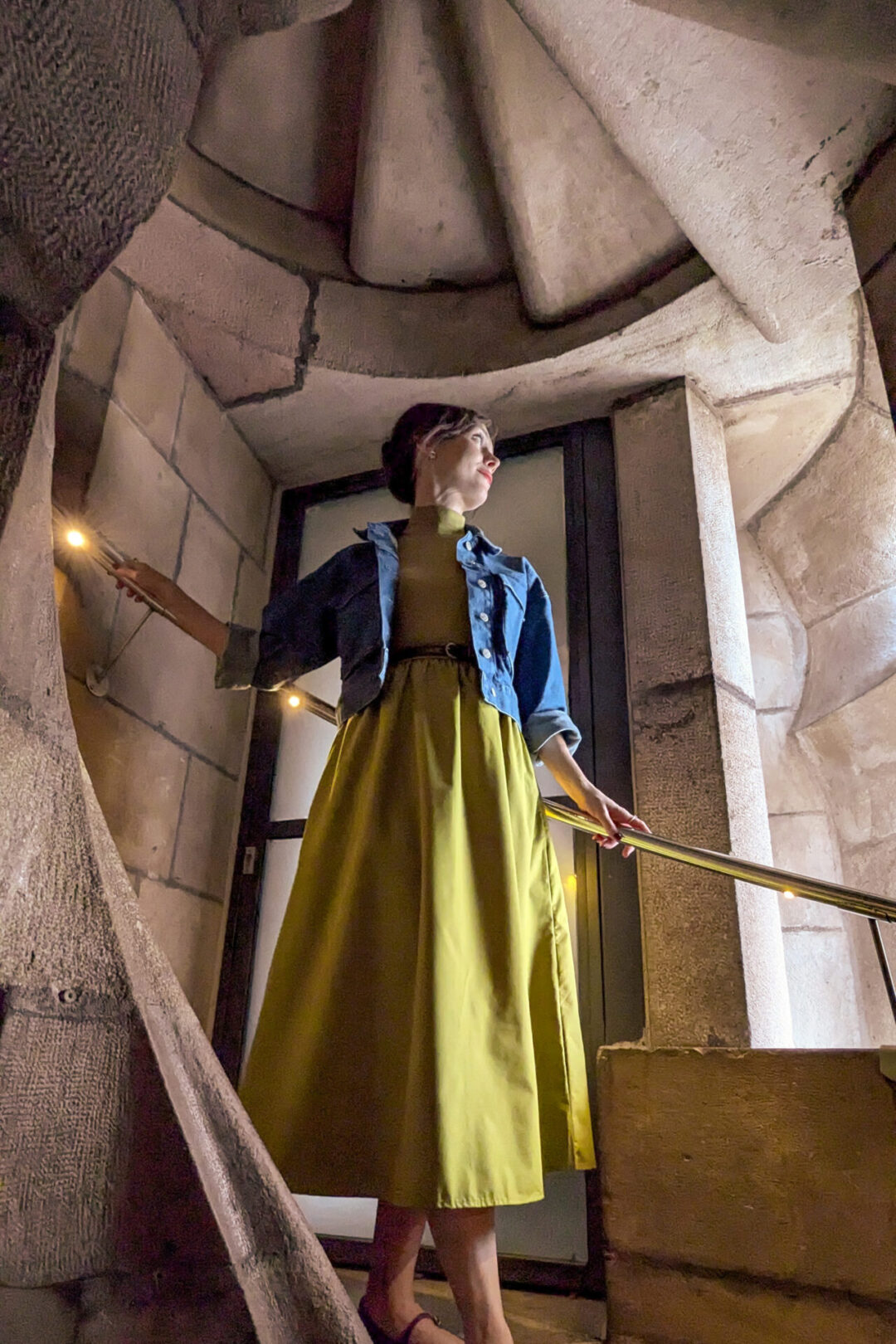 Travel Blogger Jordan Gassner looking out a window from one of the spiral tower staircases inside La Sagrada Familia in Barcelona, Spain