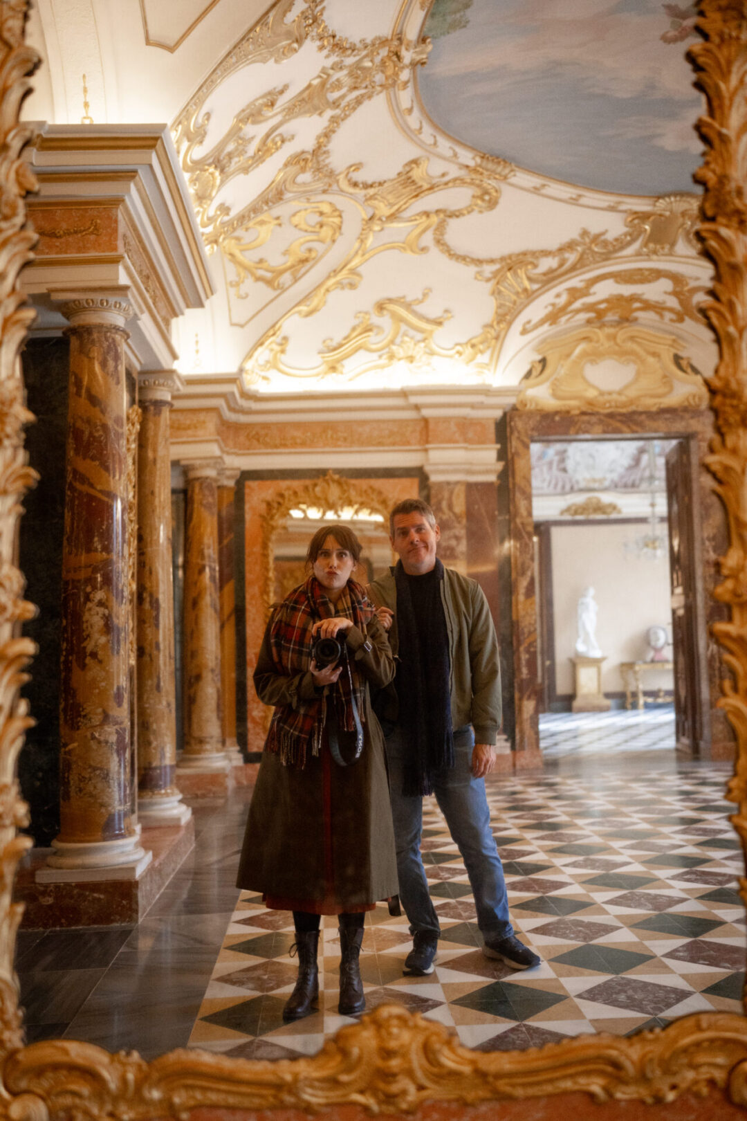 Travel Blogger Jordan Gassner and her partner taking a mirror selfie at an empty palace room in Segovia