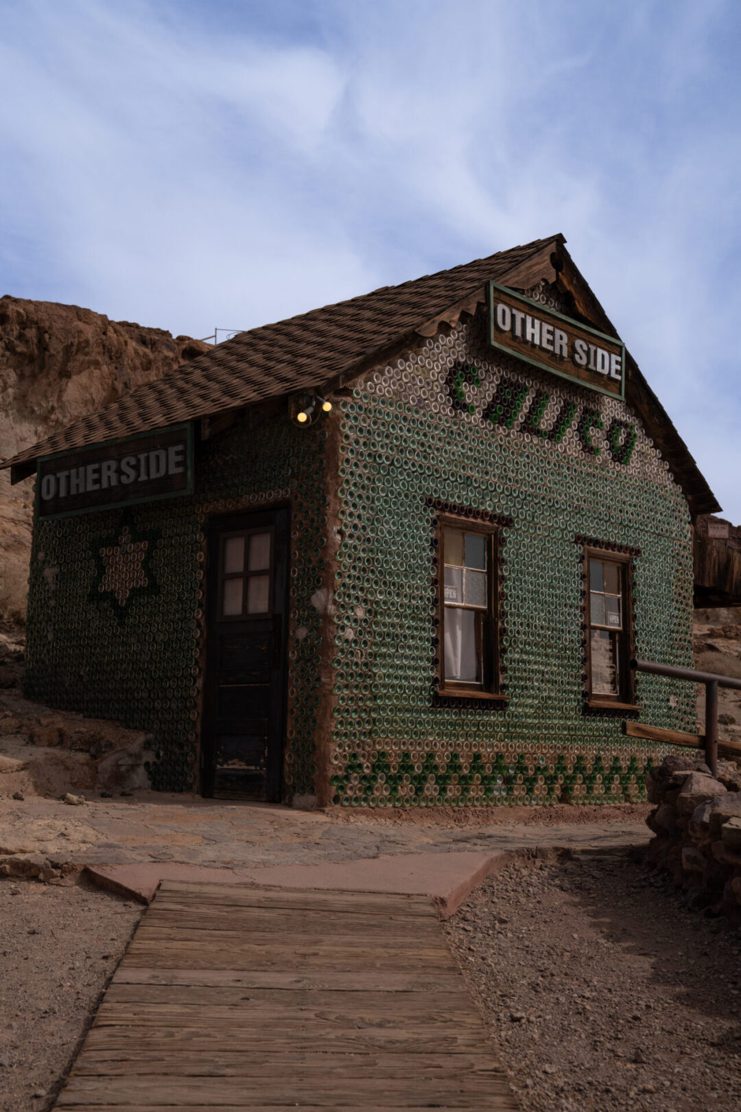 A building made of recycled bottles with the name "Calico" designed on it at Calico Ghost Town in California