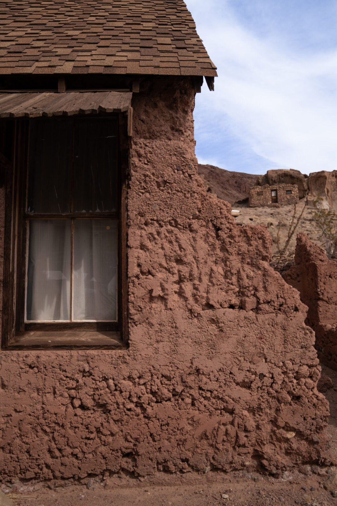 The "doll house" building and another adobe building just on the hill behind at Calico Ghost Town in California
