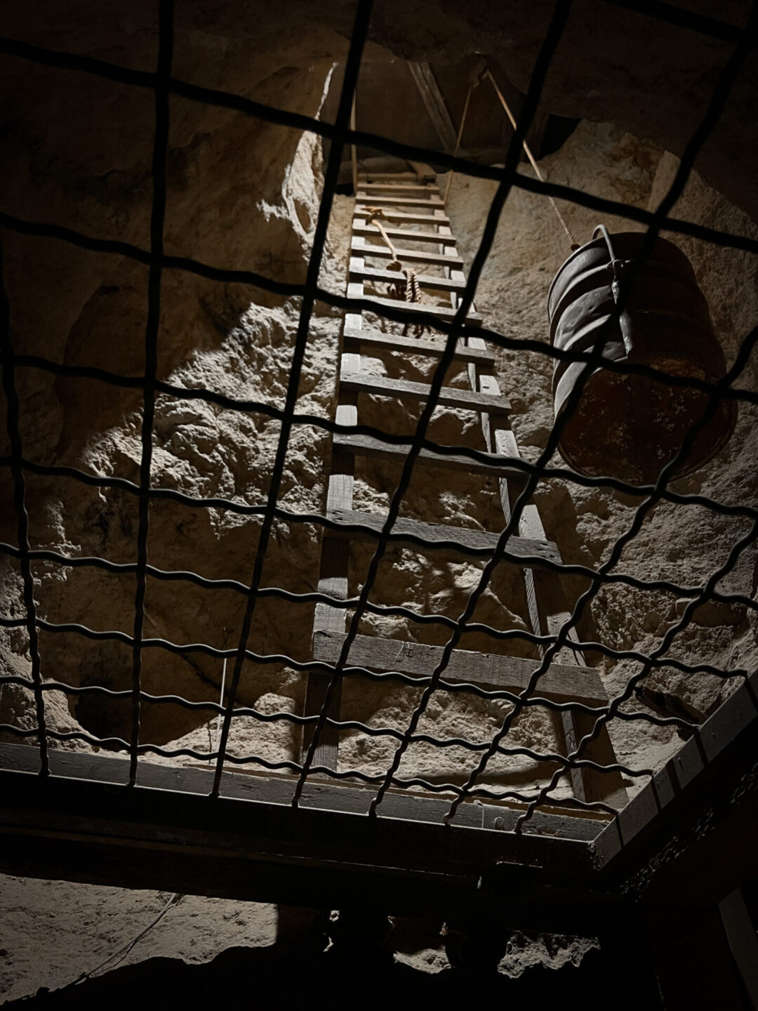 A bucket and wooden staircast leading down into Calico Ghost Town's Maggie Mine in California