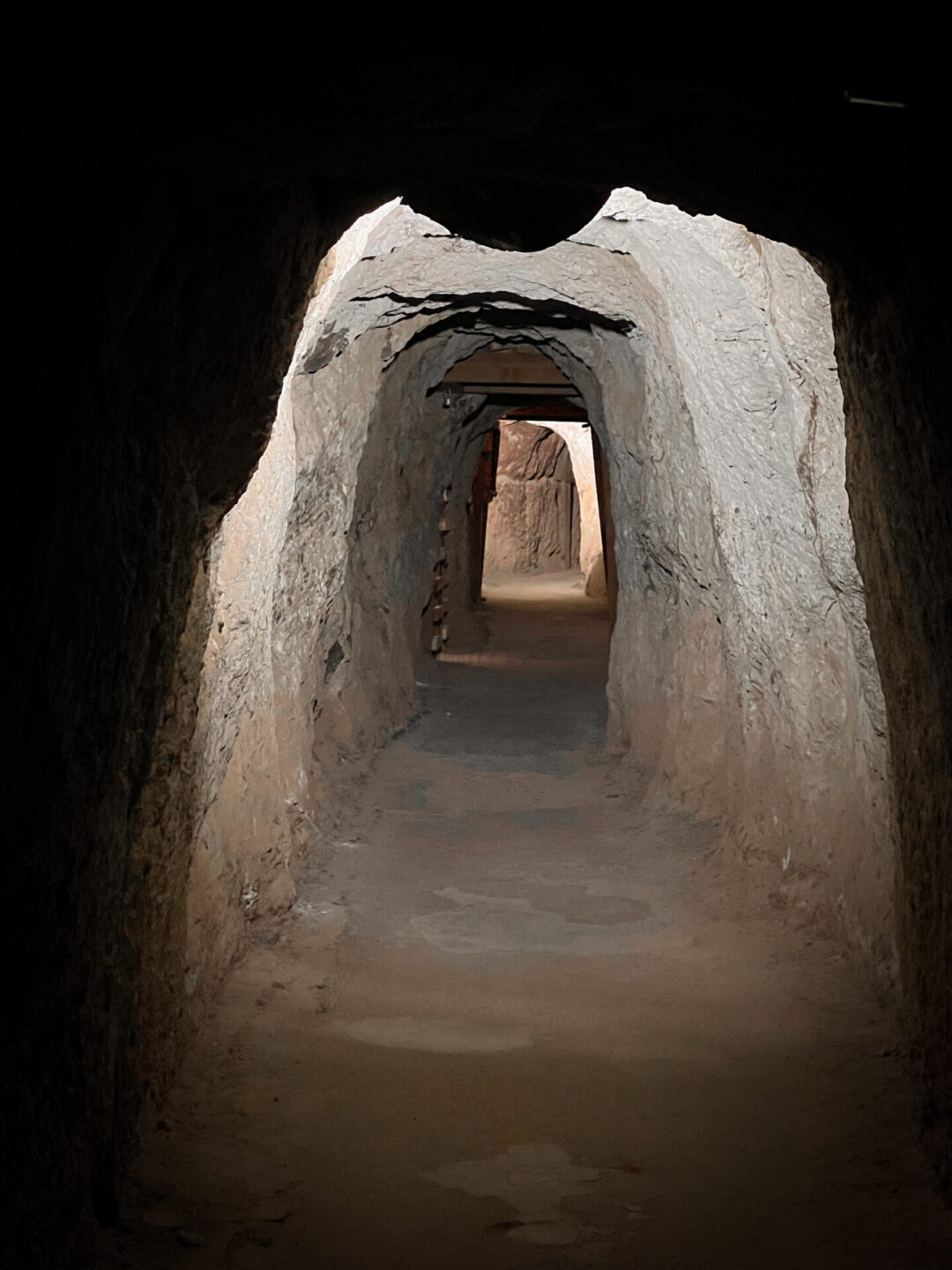 A dimly lit tunnel at Calico Ghost Town's Maggie Mine in California