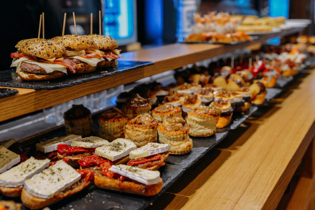 A display case with Spanish pintxos (Basque tapas) inside Mercado de Ribera in Bilbao, Spain