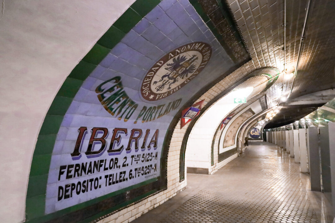 A vintage advertisement reading "Iberia" at Chamberi Ghost Station in Madrid, Spain